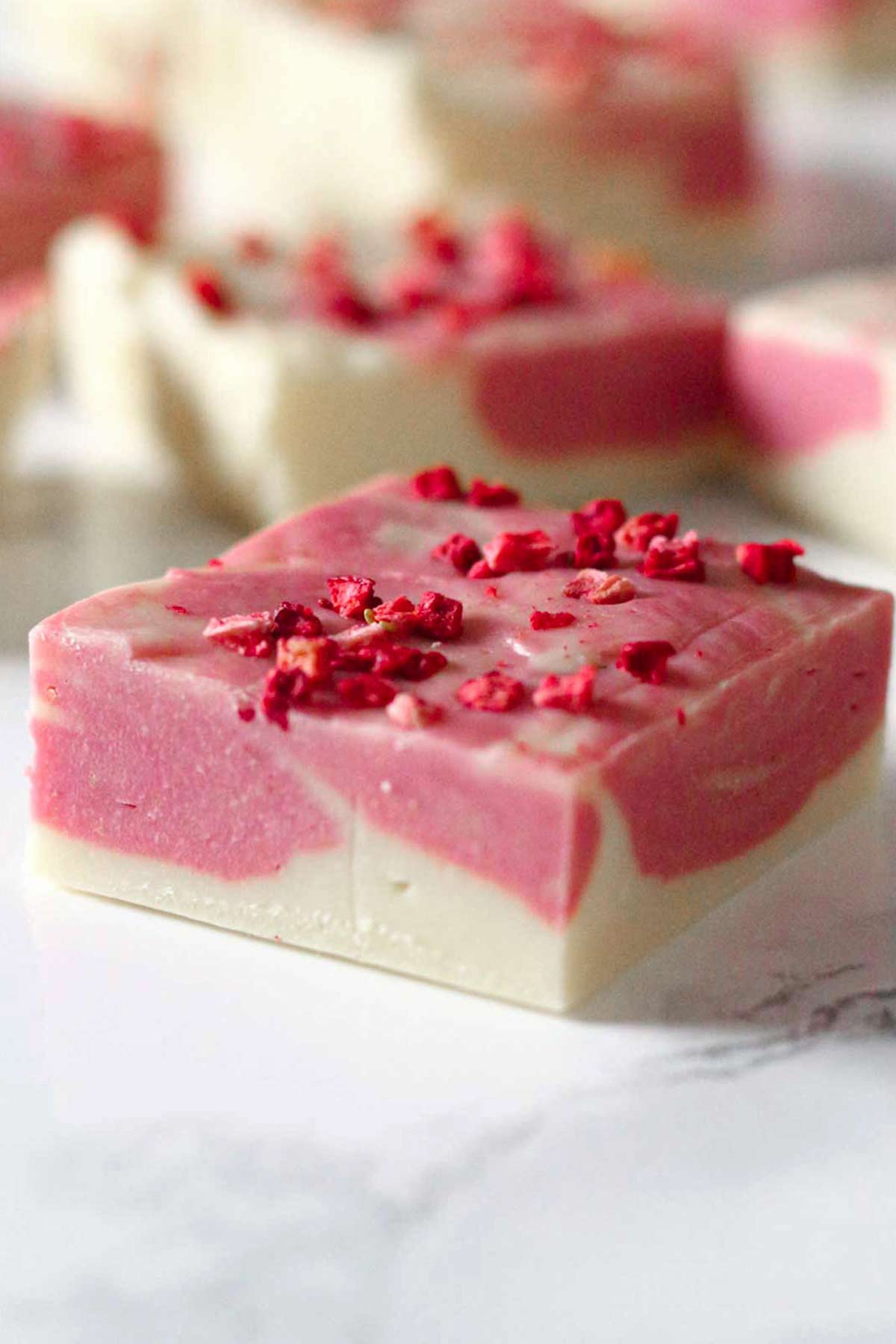 square of white chocolate strawberry fudge on a worktop