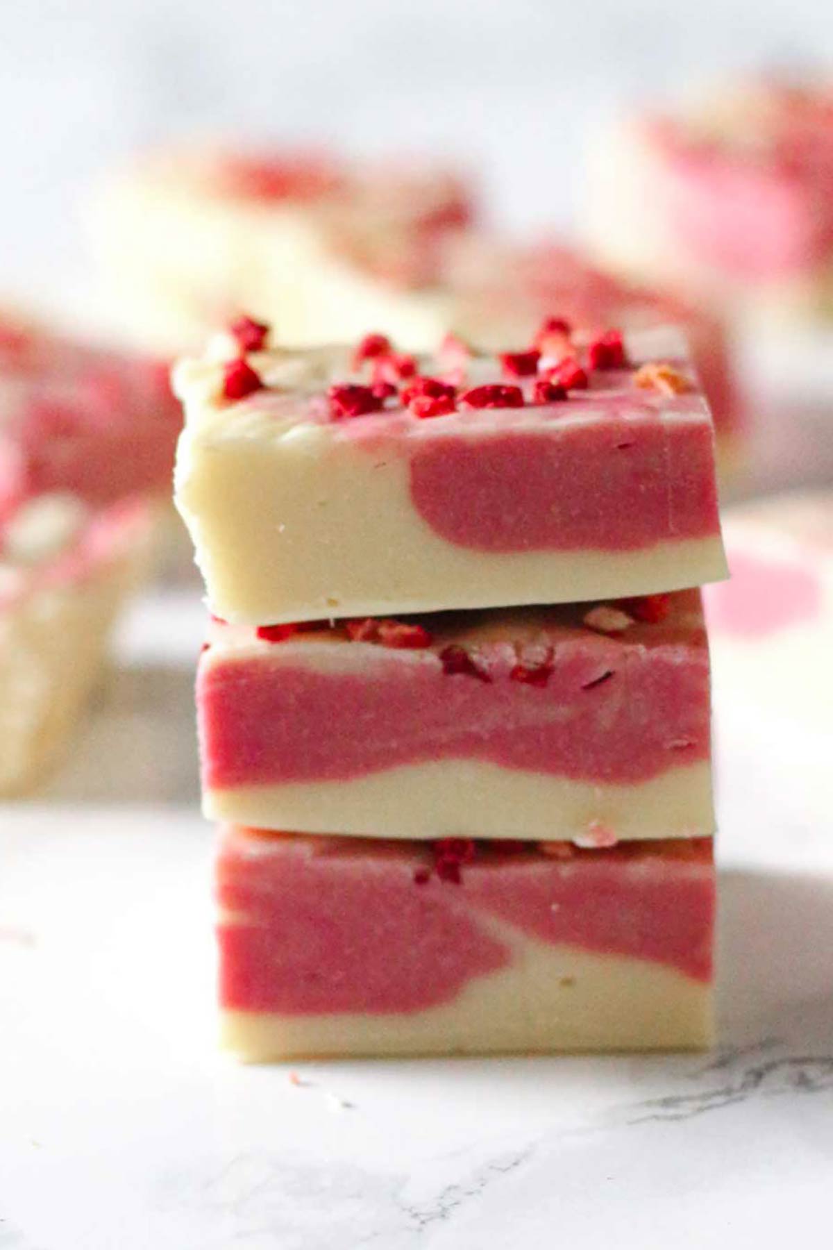 stack of 3 pieces of white chocolate strawberry fudge