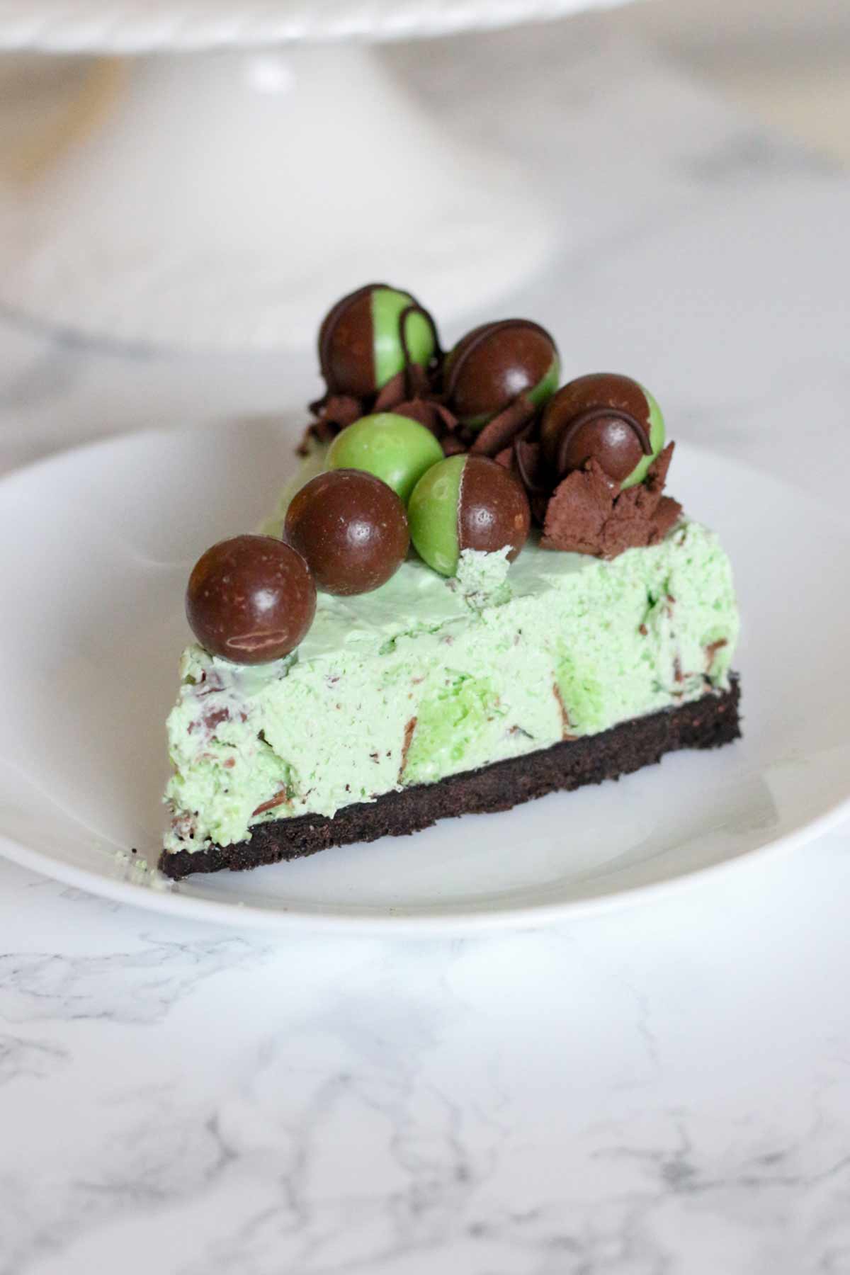 slice of no bake mint aero cheesecake with aero bubbles on top