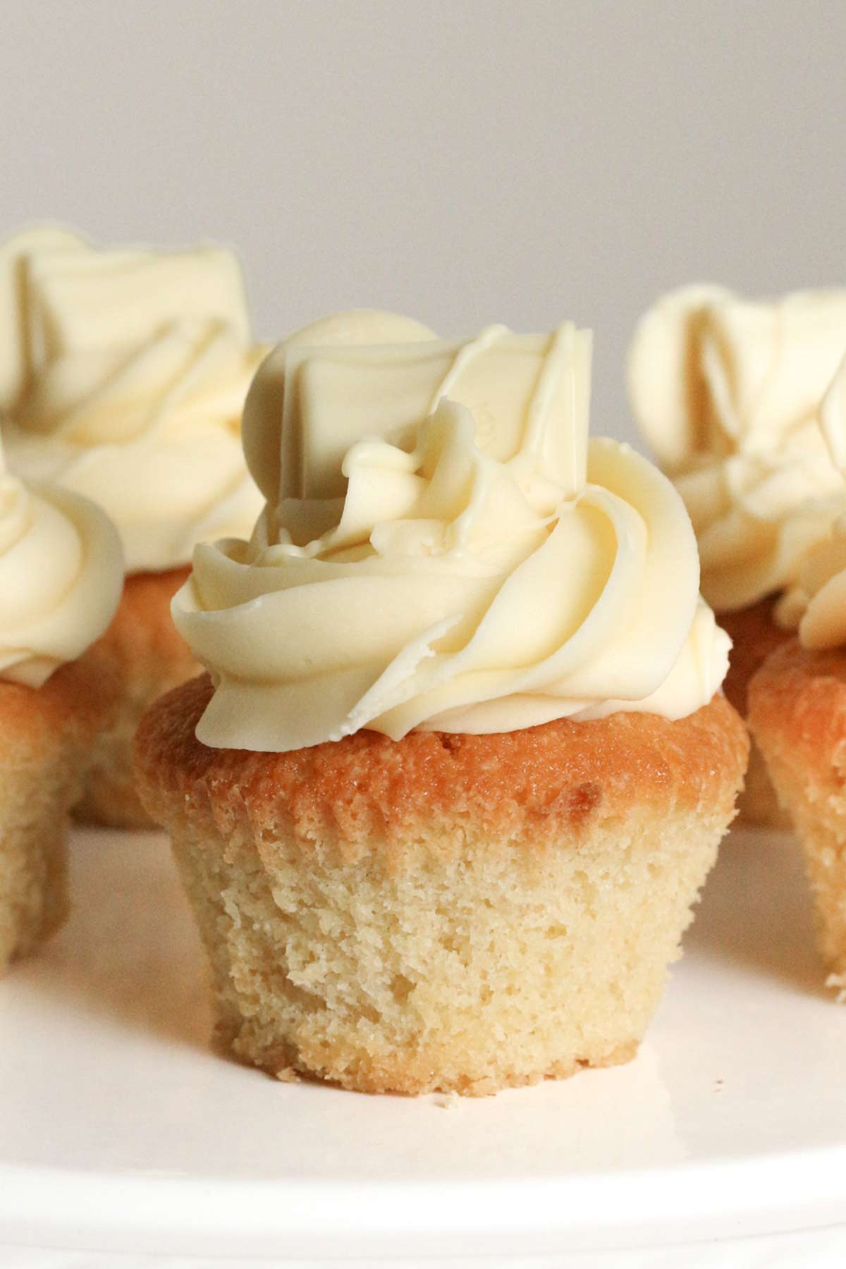 milky bar cupcakes on a white cake stand