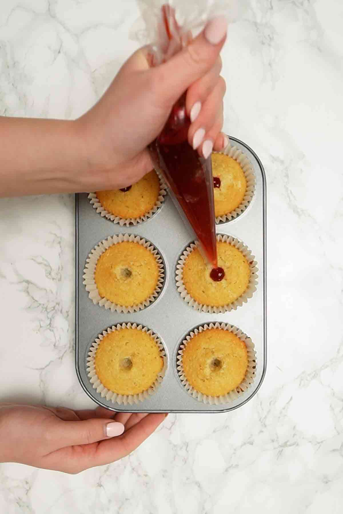 piping jam into cakes