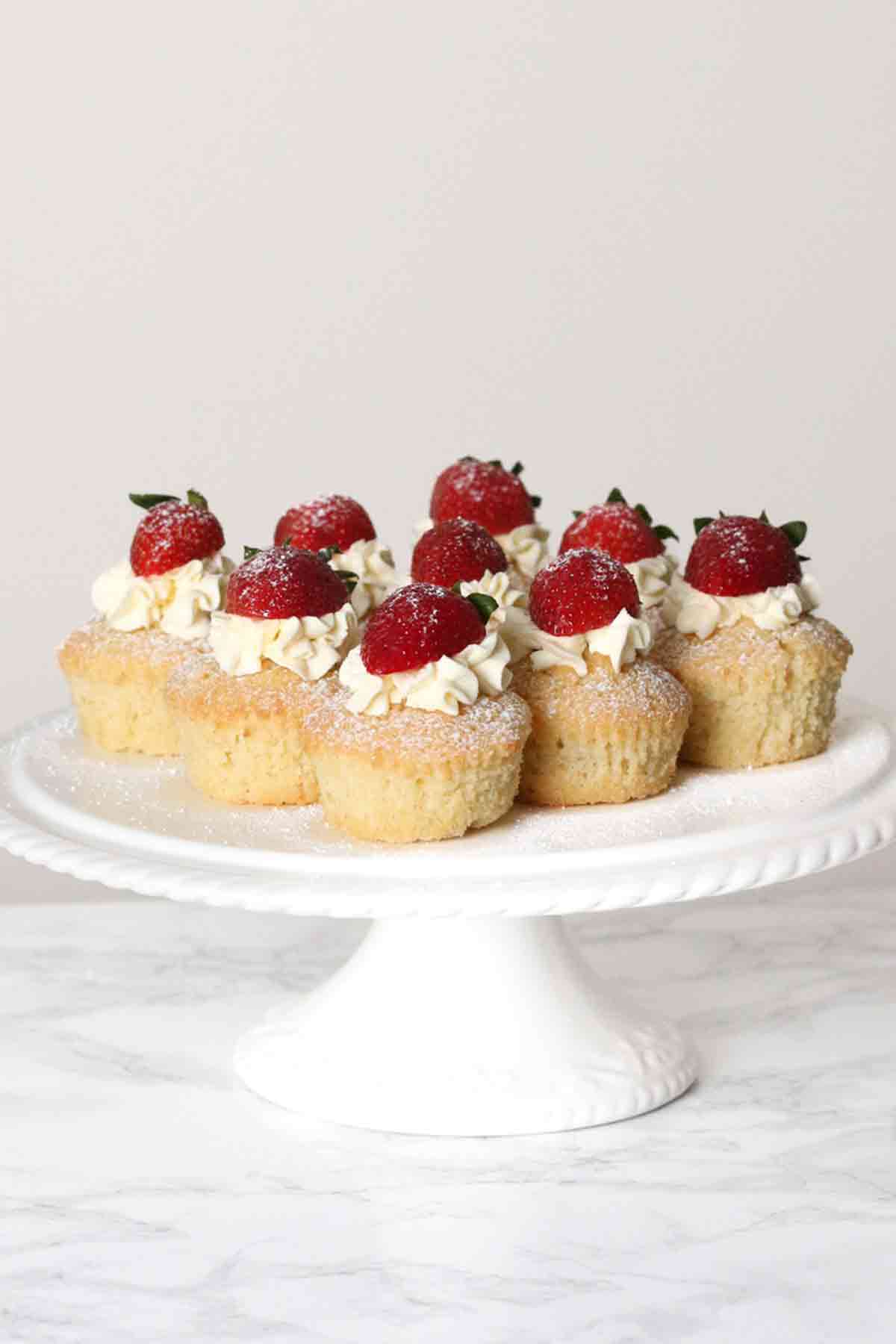 white cake stand full of victoria sponge cupcakes
