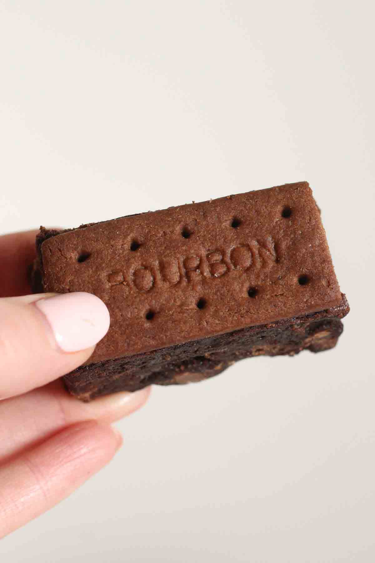 hand holding chocolate bourbon biscuit brownie