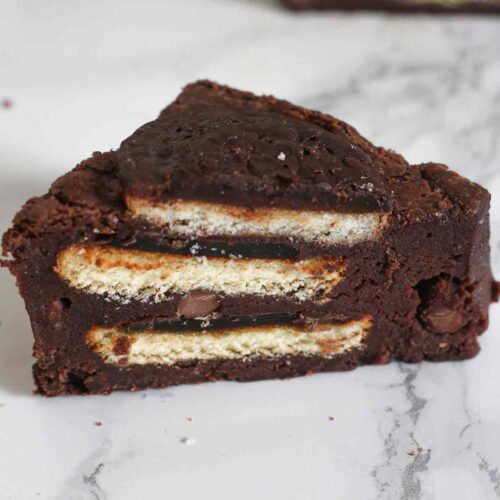 single triangle of jaffa brownies on a white surface