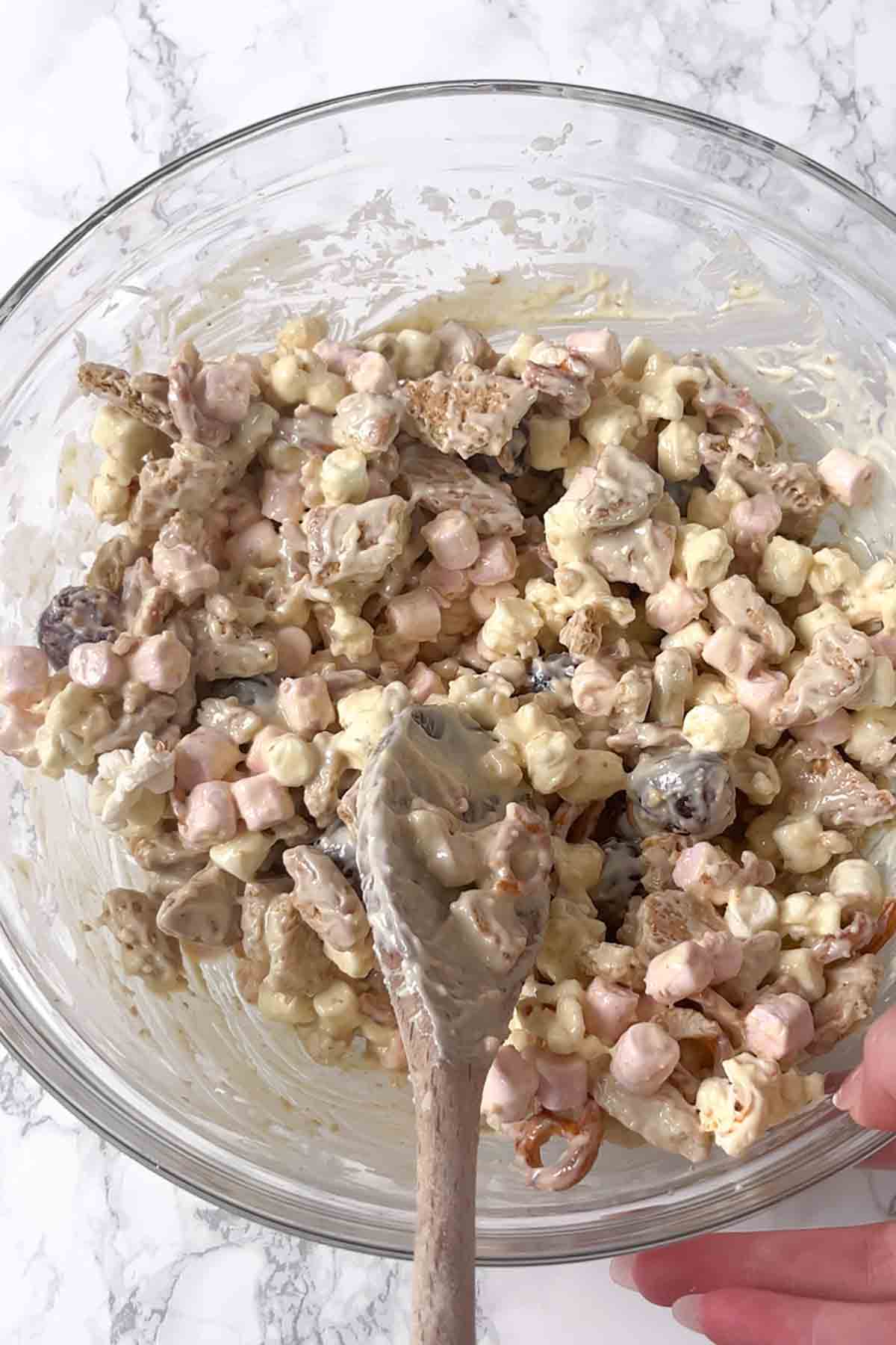 ingredients in a bowl covered with melted white chocolate