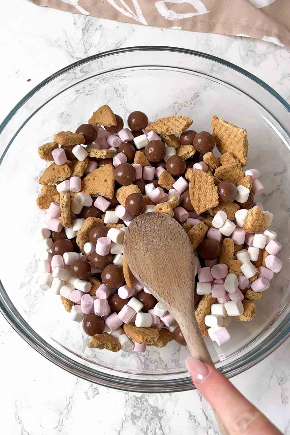 maltesers mixed with other dry ingredients in a bowl