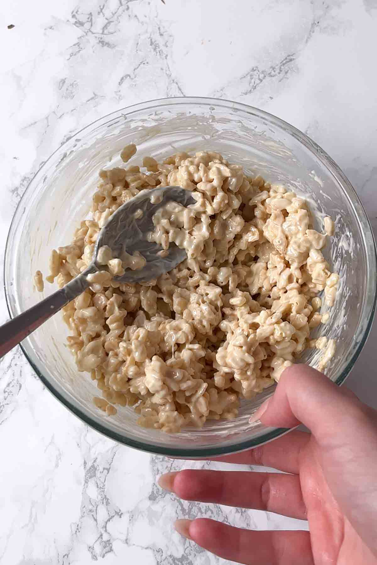 bowl of rice krispies mixed with melted chocolate