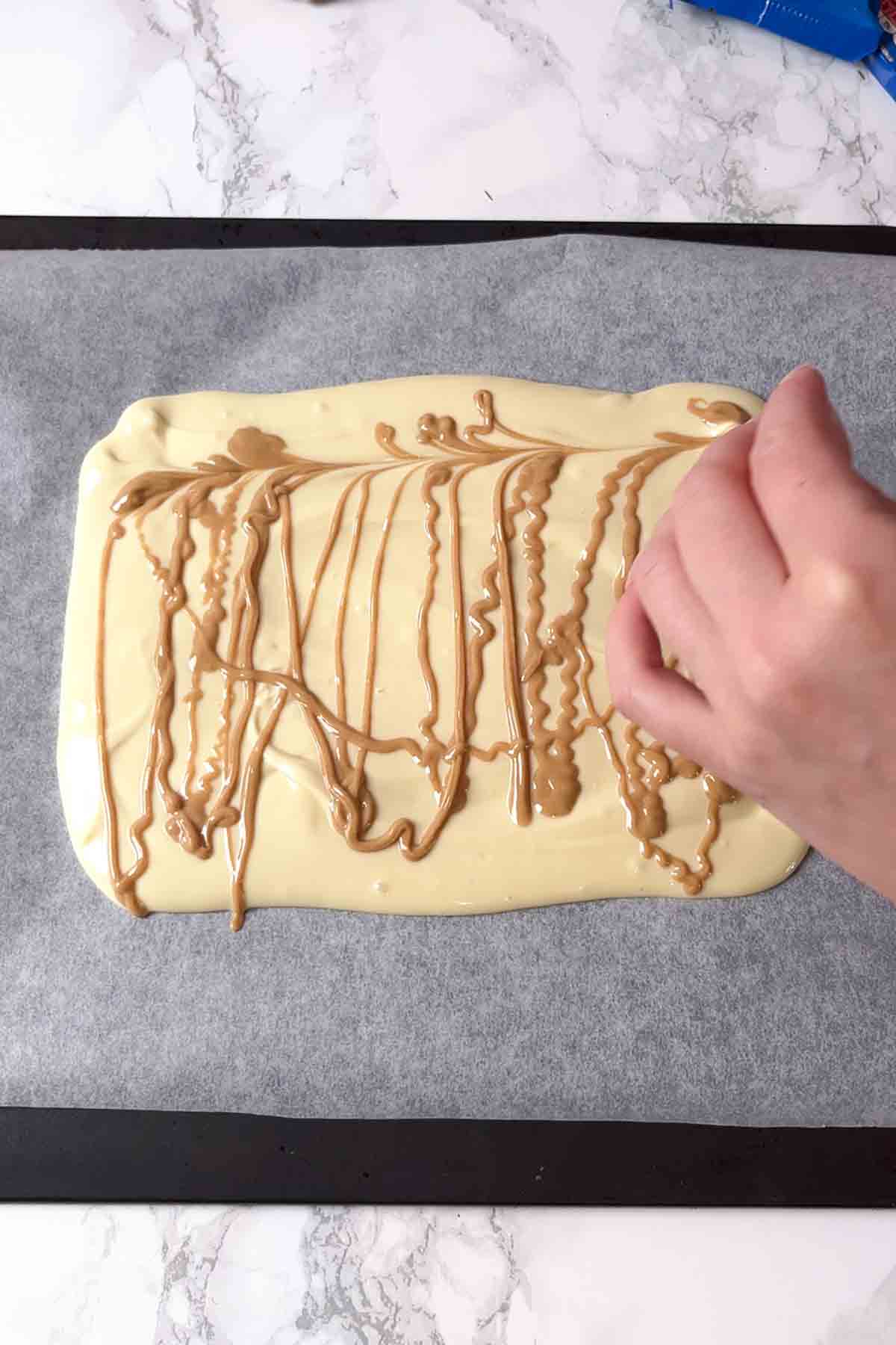 peanut butter drizzled over melted white chocolate