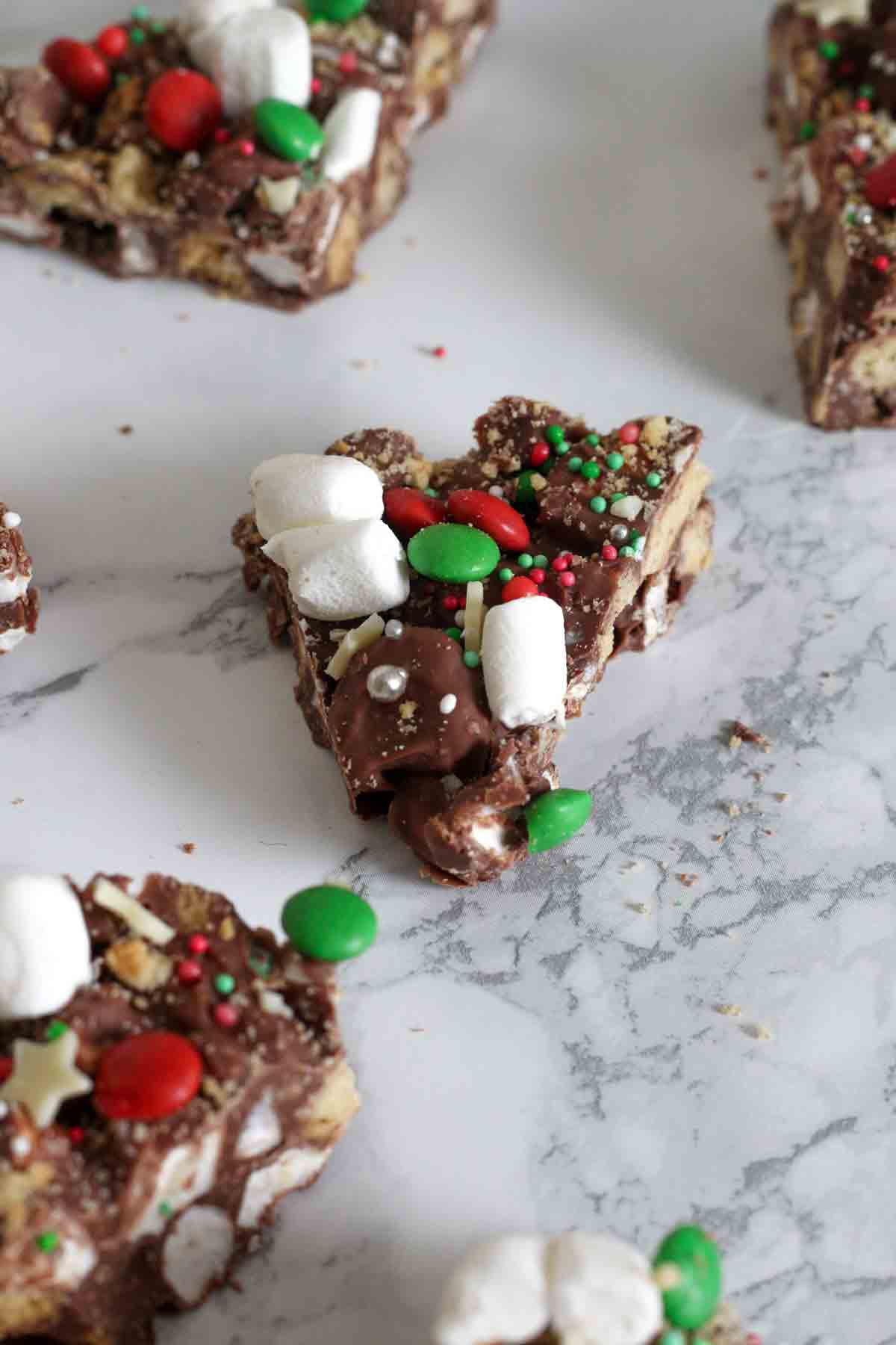 pieces of christmas smores bark on a white marble surface