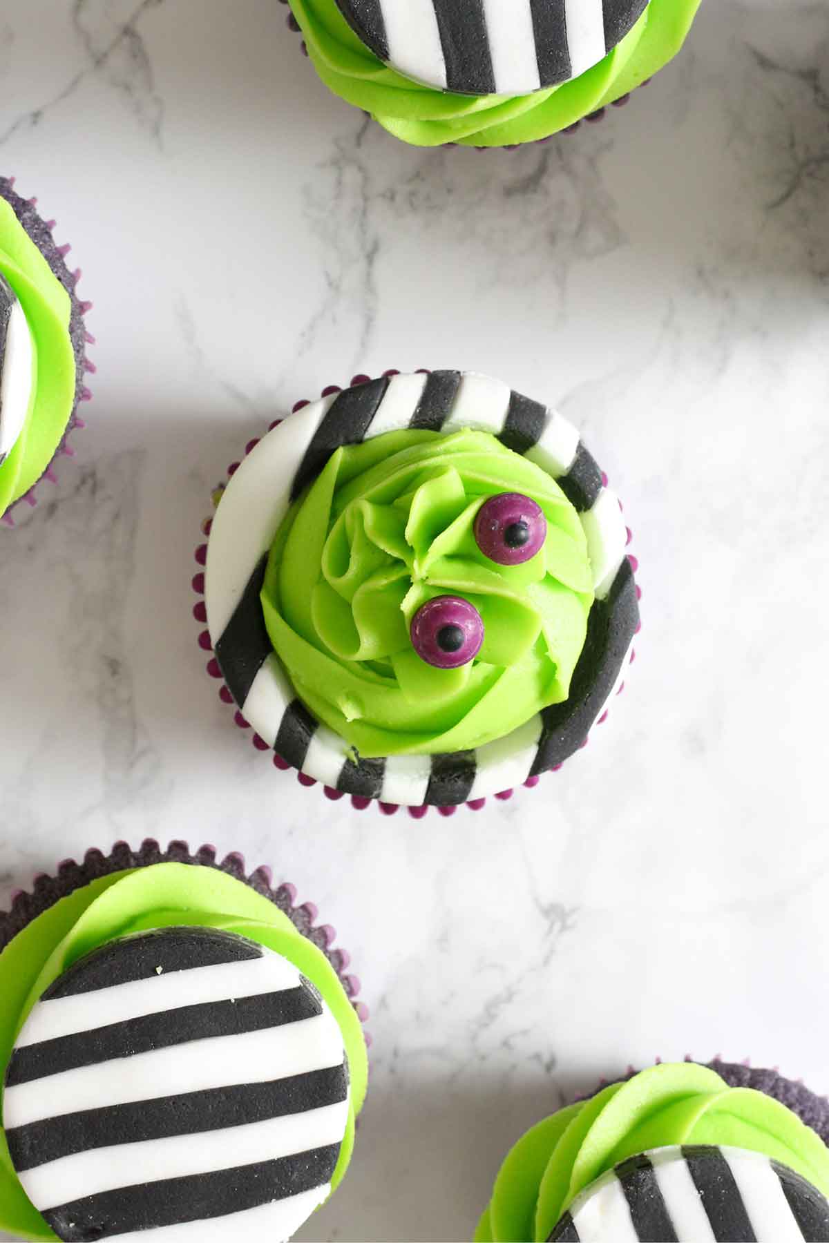 overhead shot of sandworm and johnny inspired beetlejuice cupcakes