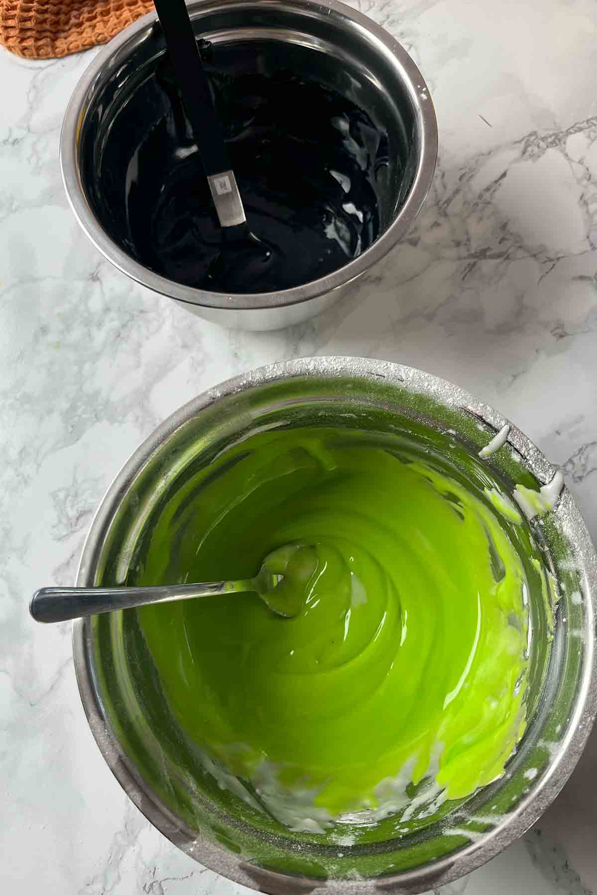 bowls of green and black icing