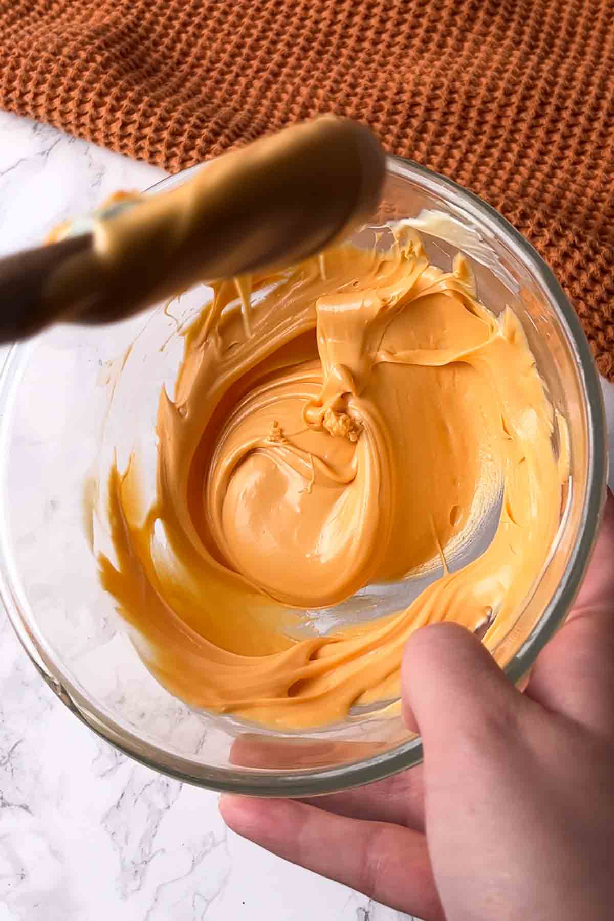 melted orange white chocolate in a bowl
