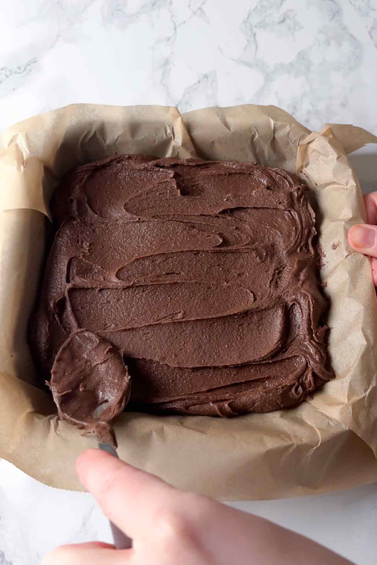 brownie box mix batter in a lined tin