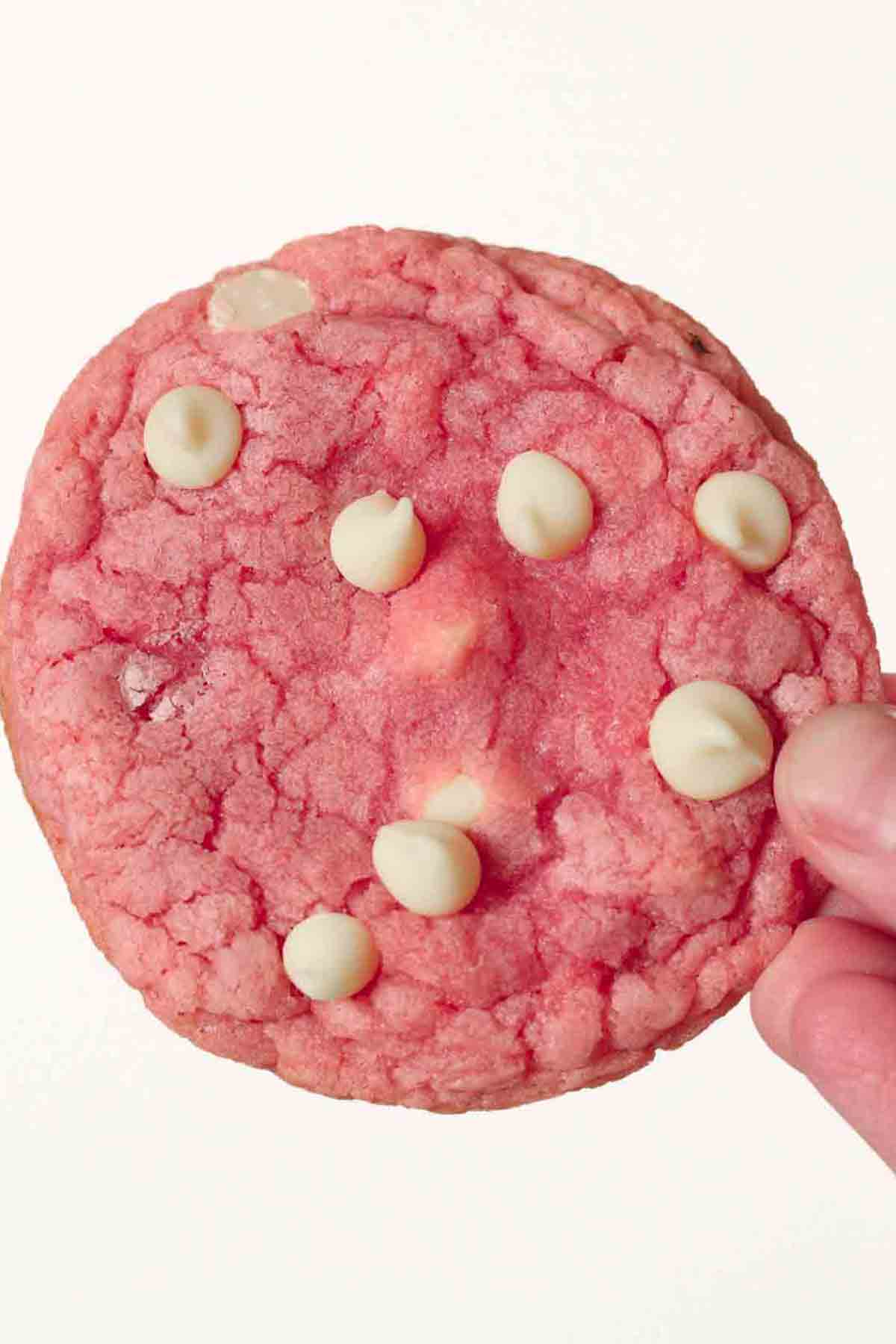 hand holding up one strawberry nesquik cookie