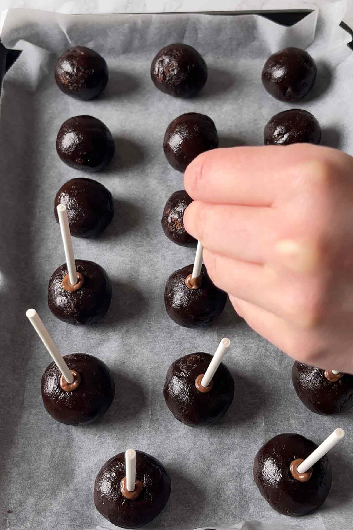 inserting the cake pop sticks