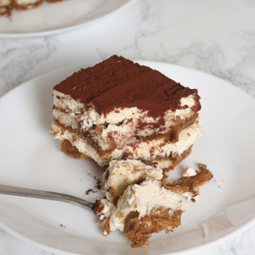 slice of decaf tiramisu with a spoonful taken out of it