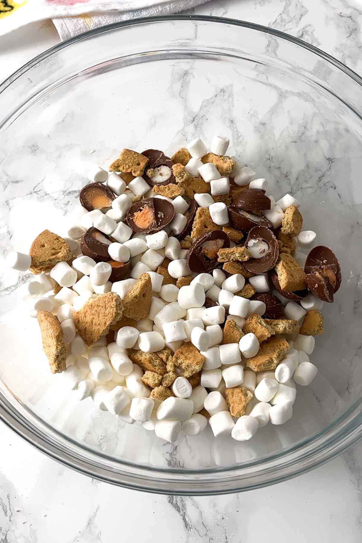biscuits marshmallows and creme eggs mixed together in a glass bowl
