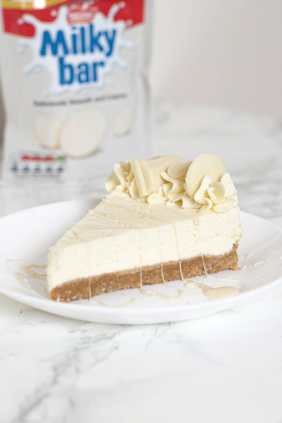 a slice of milky bar cheesecake on a plate