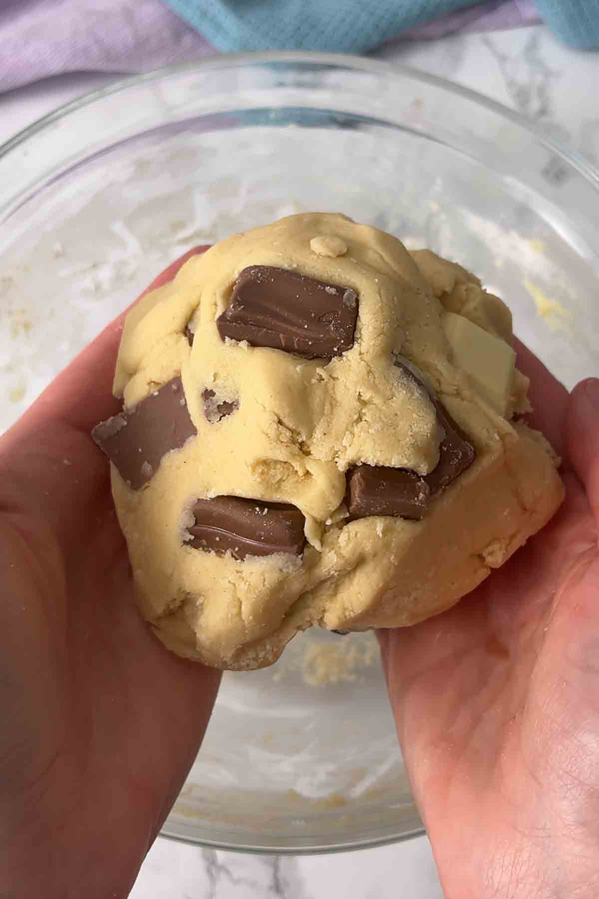 ball of dough with galaxy chunks and white chocolate pieces in it