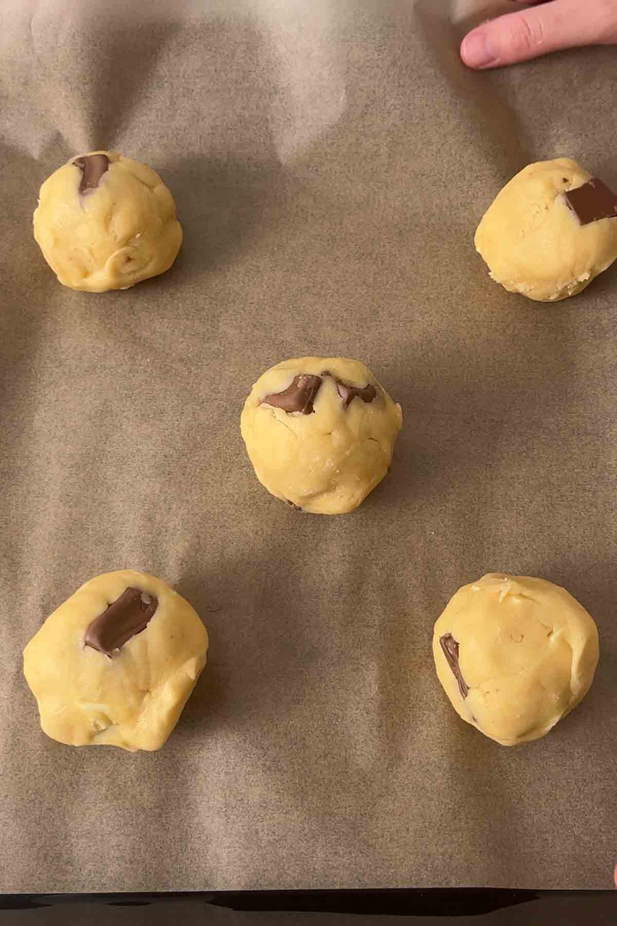 balls of cookie dough on lined tray