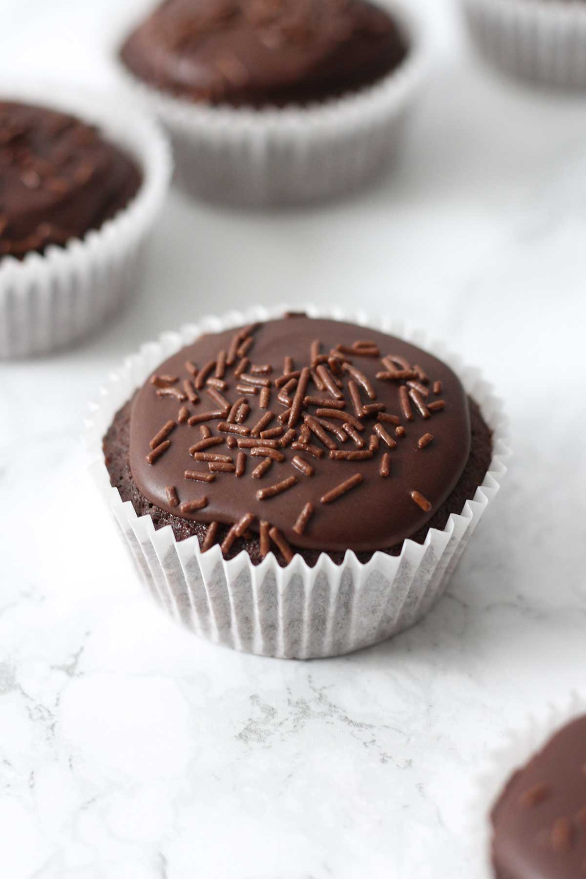 chocolate fairy cupcakes on a white surface