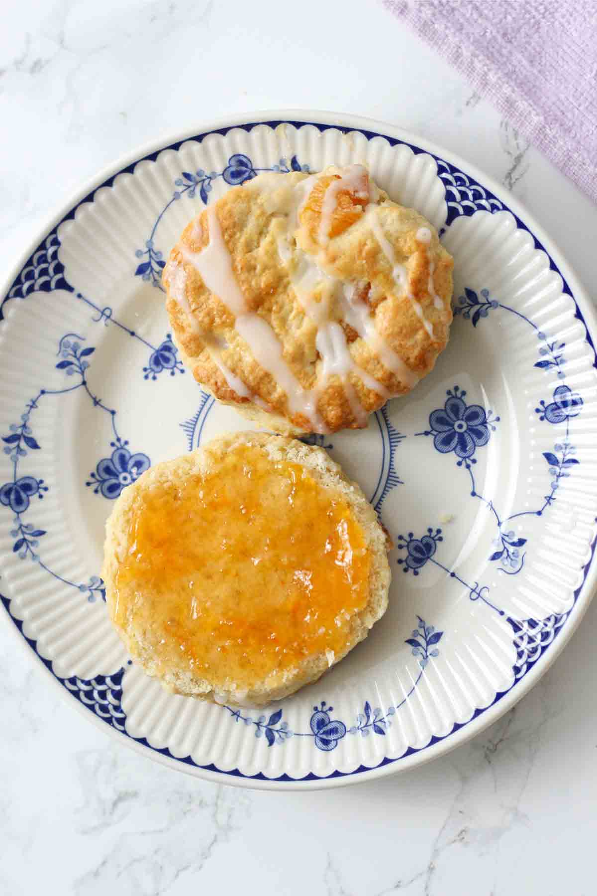 overhead image of apricot scones on a plate with apricot jam on one half