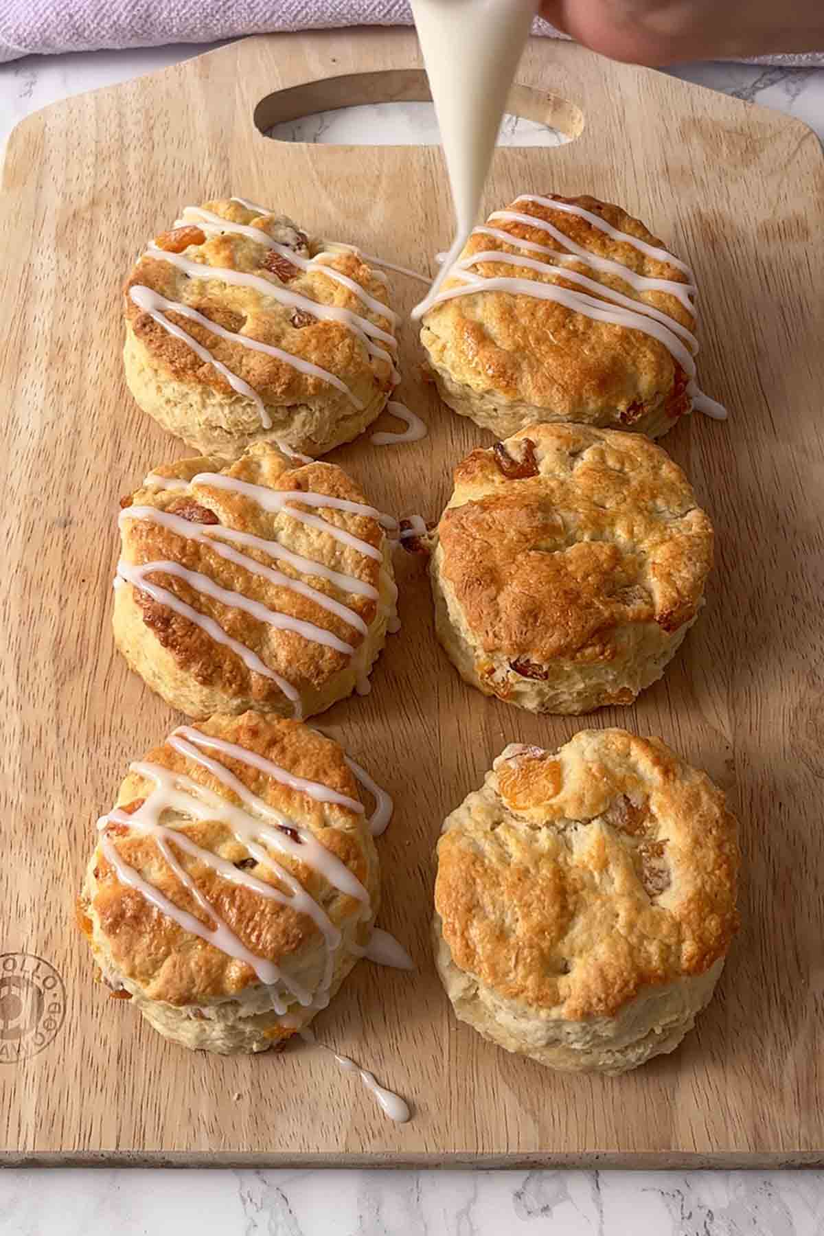 piping icing onto the scones