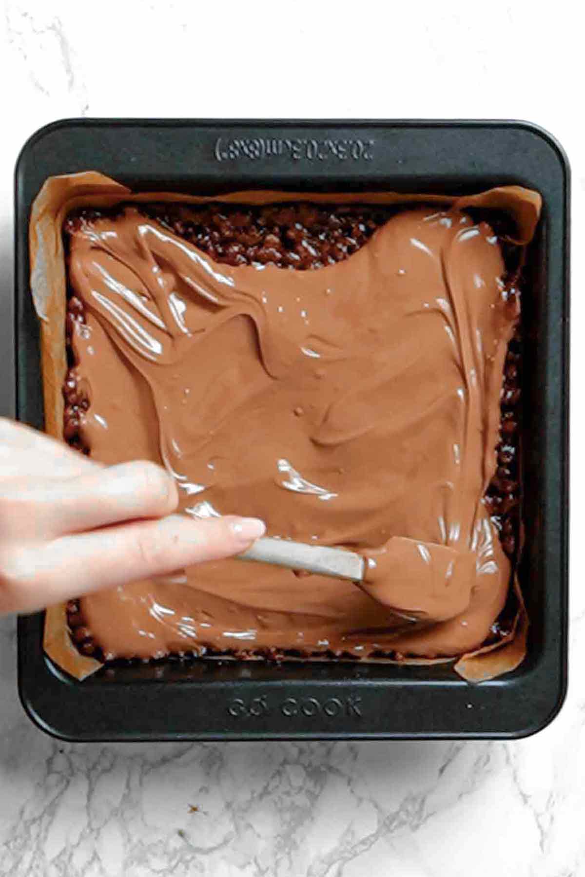 spreading milk chocolate on top