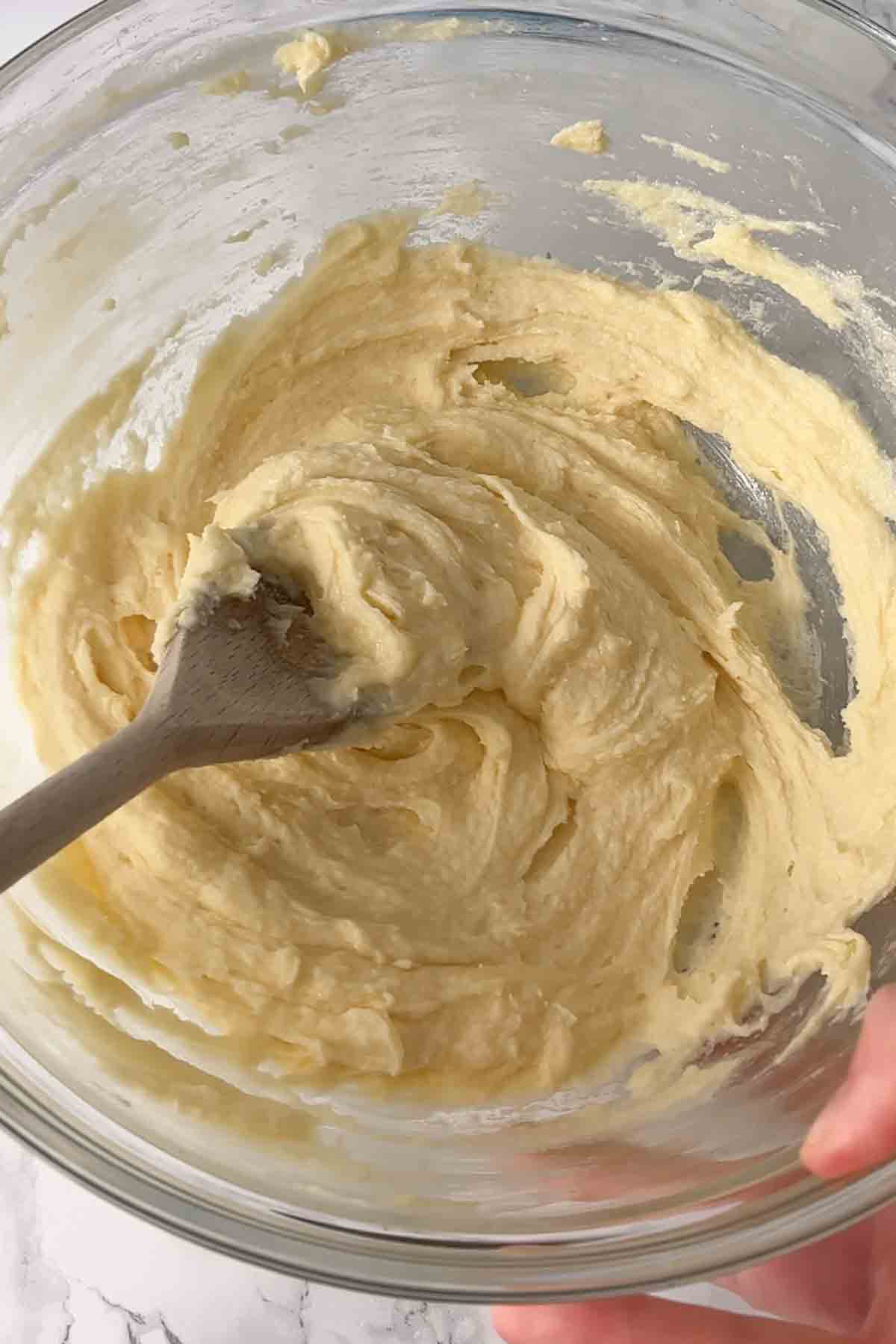 sugar butter and egg mixed together in a bowl