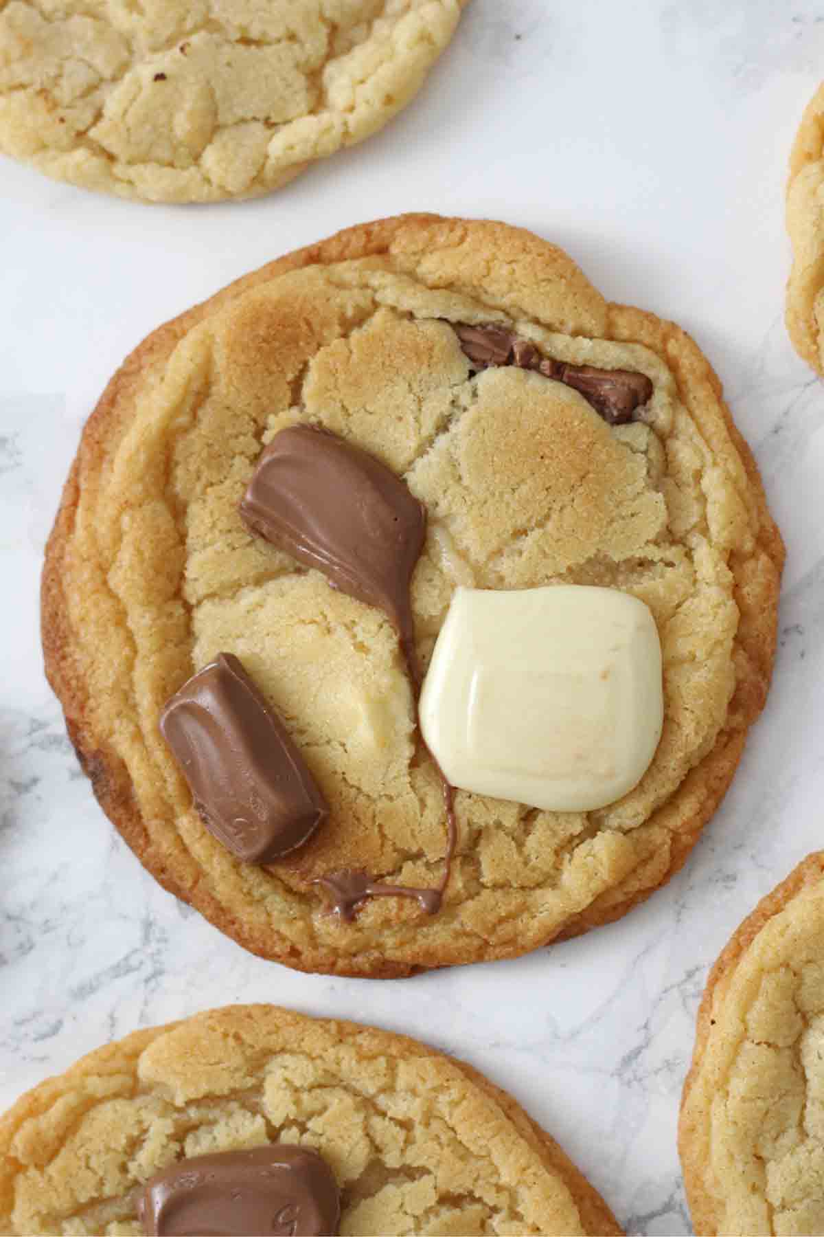 tanya burr milk and white chocolate cookies on a white surface