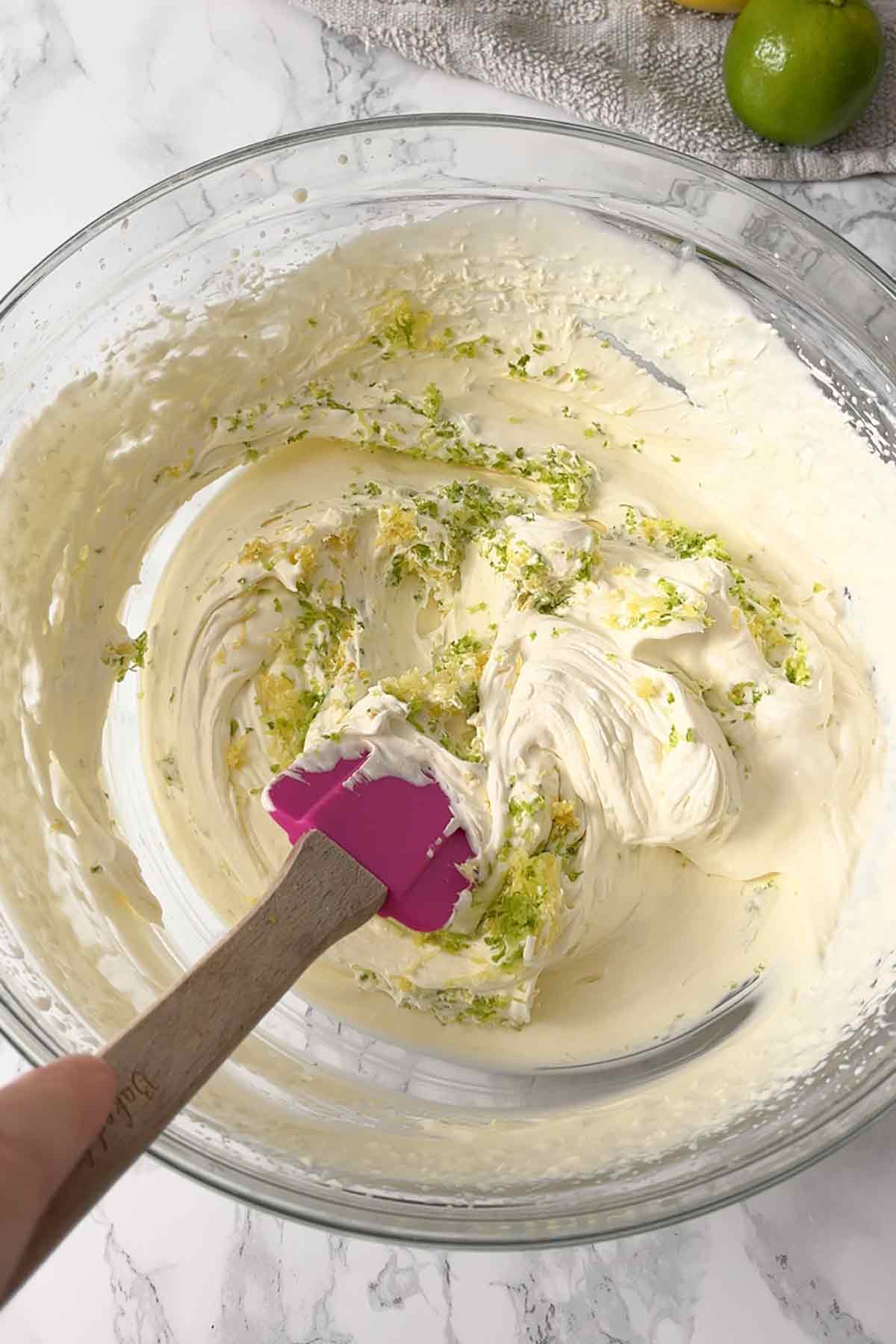 folding lemon and lime zest into the mixture