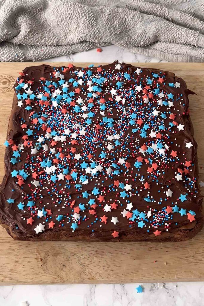 frosted brownie covered with red and blue sprinkles