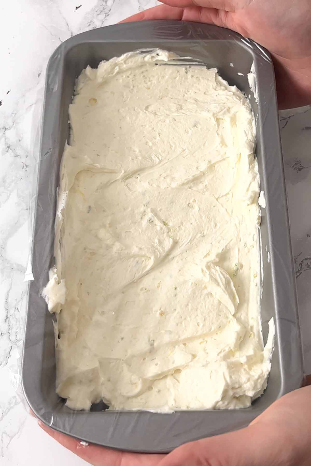ice cream batter in tin with cling film