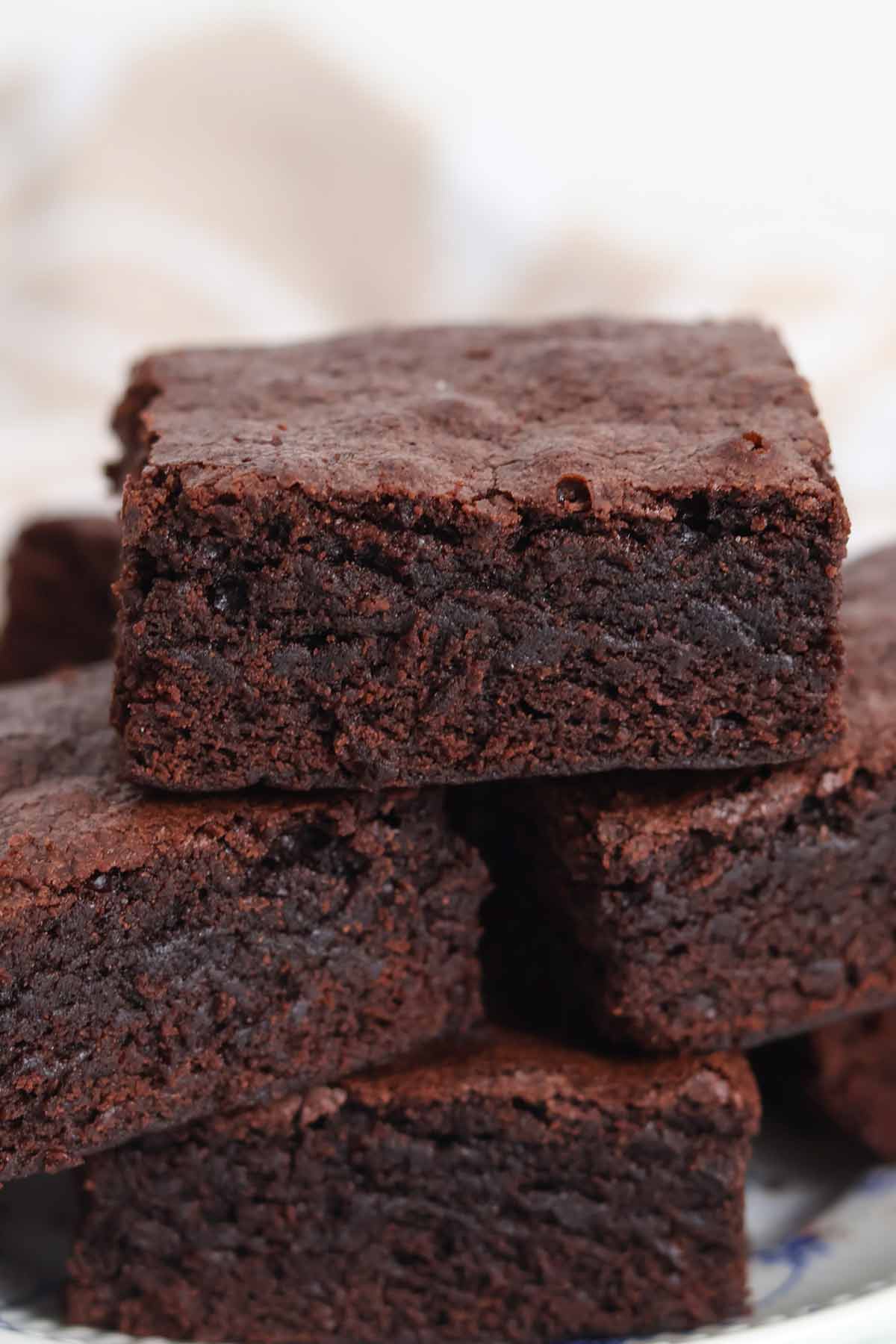stack of cakey chocolate brownies on a plate