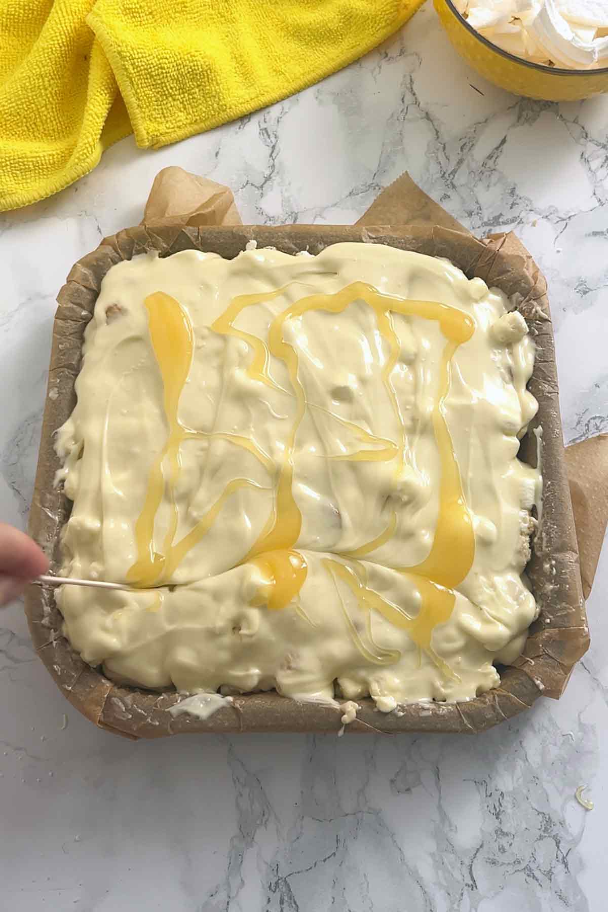 swirling lemon curd into the white chocolate