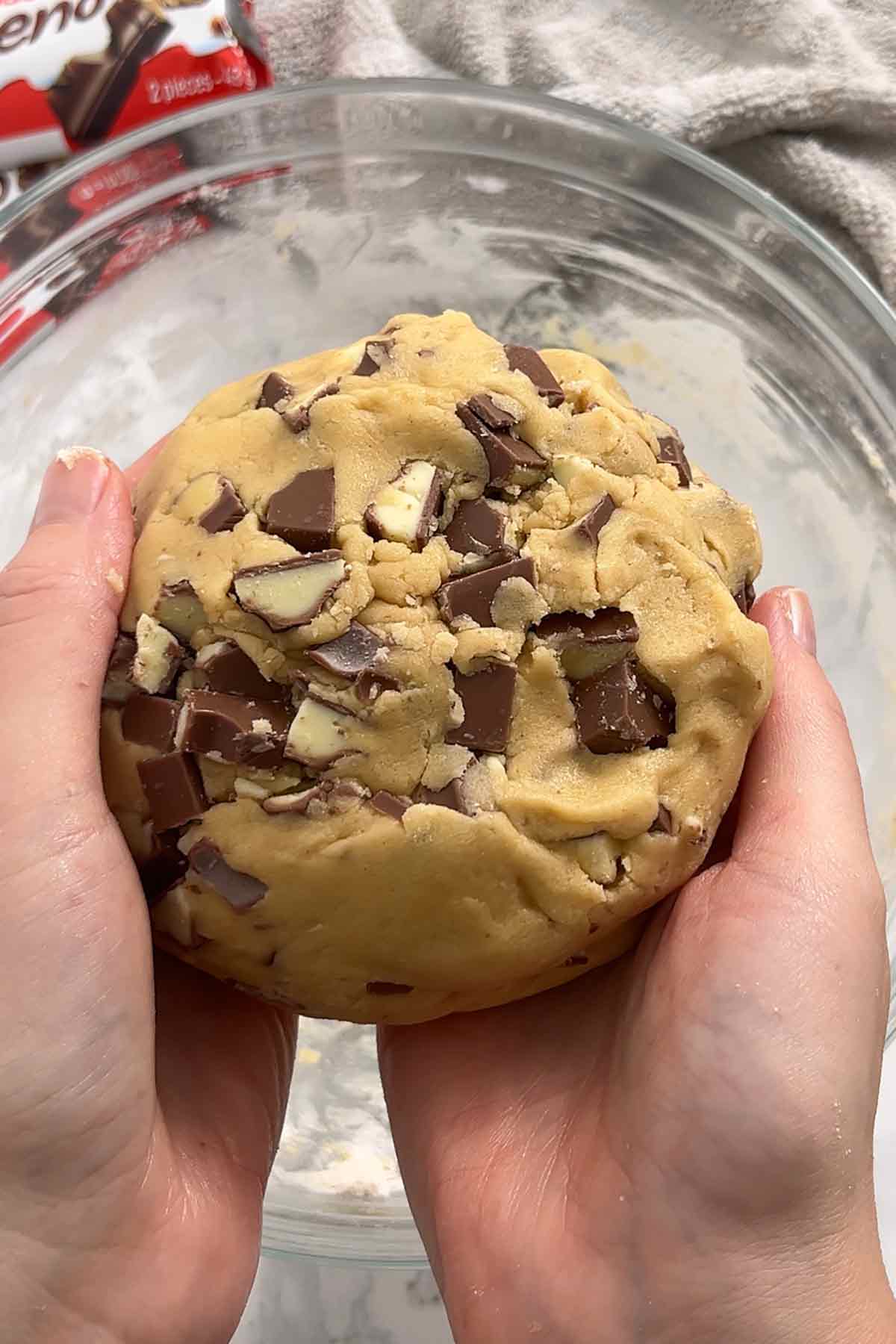 ball of cookie dough with kinder chocolate in it