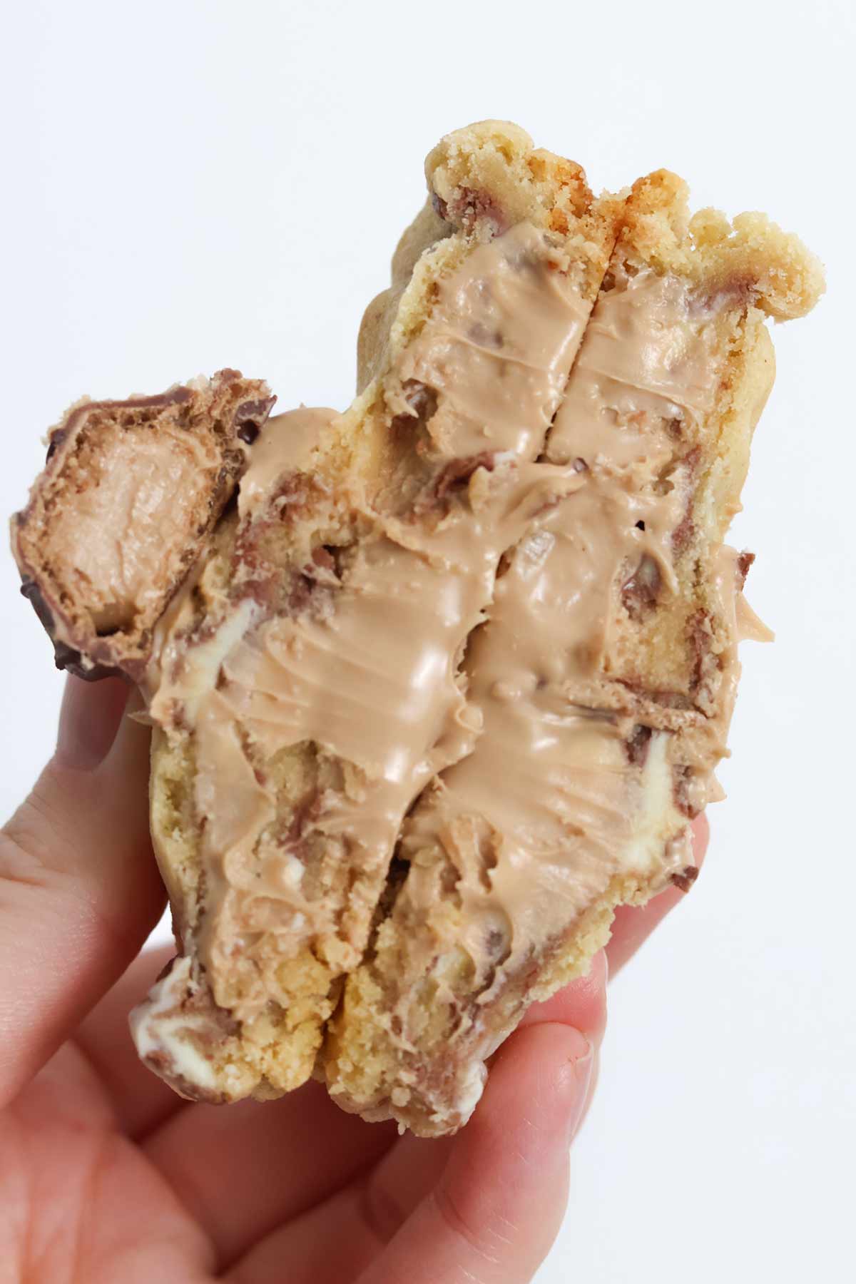hand holding up kinder bueno stuffed nyc cookie
