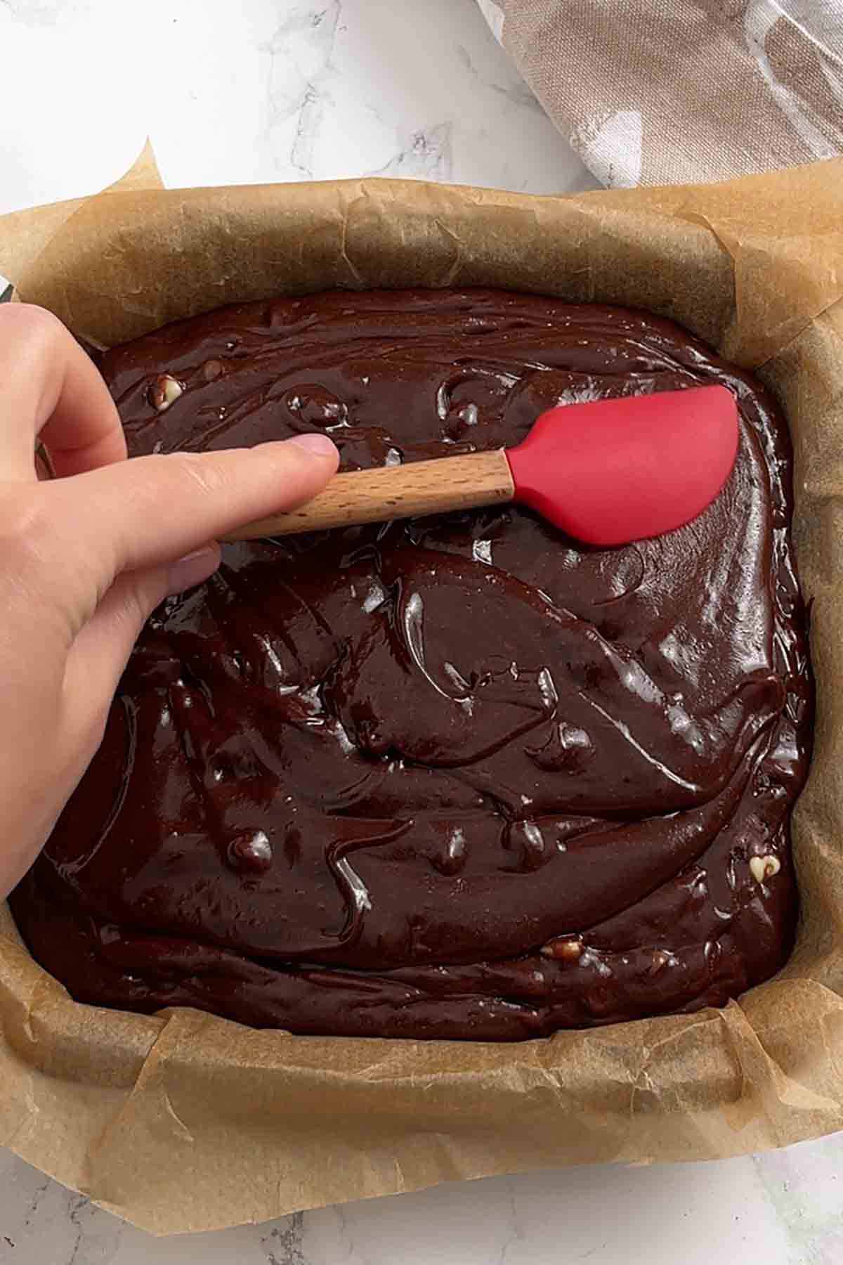 lined traybake tin with chocolate batter inside