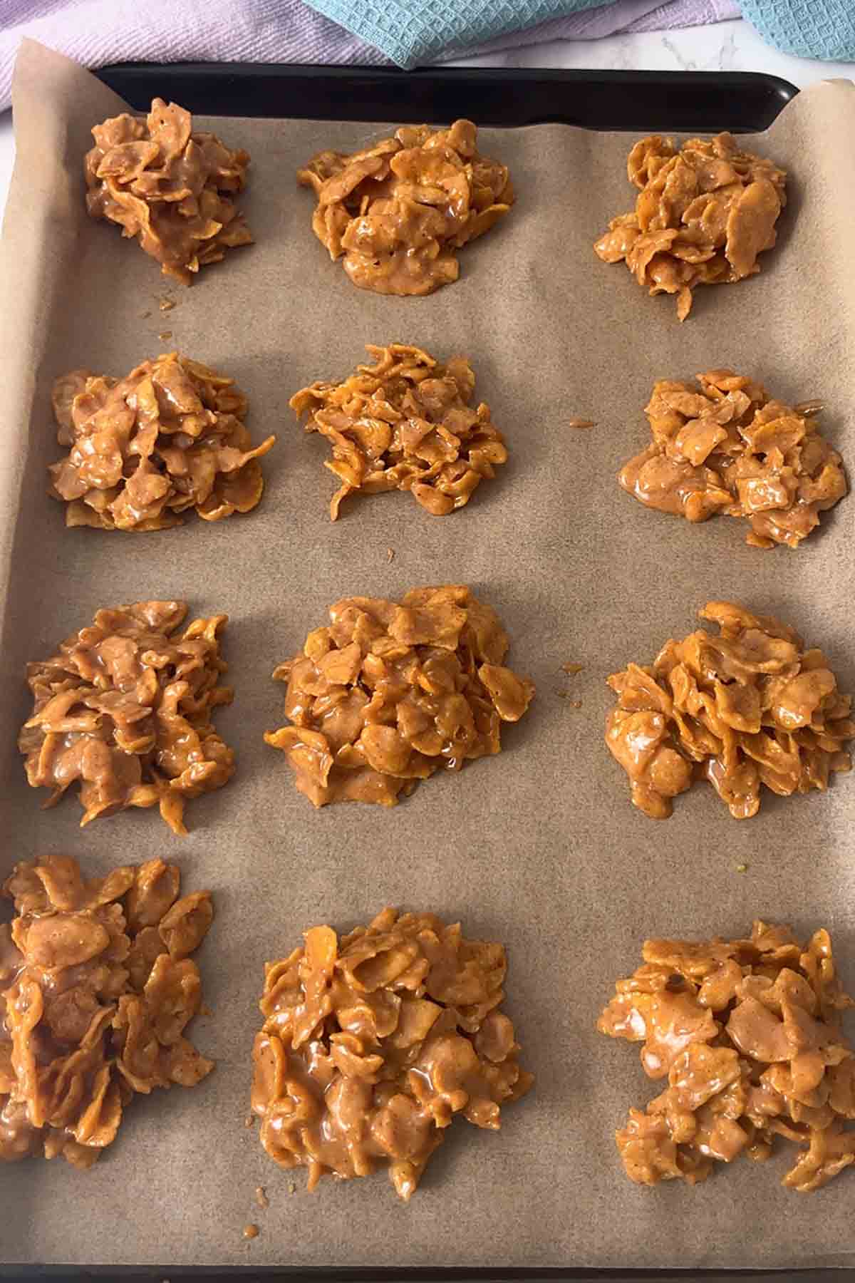mounds of cornflake mixture on a lined baked tray