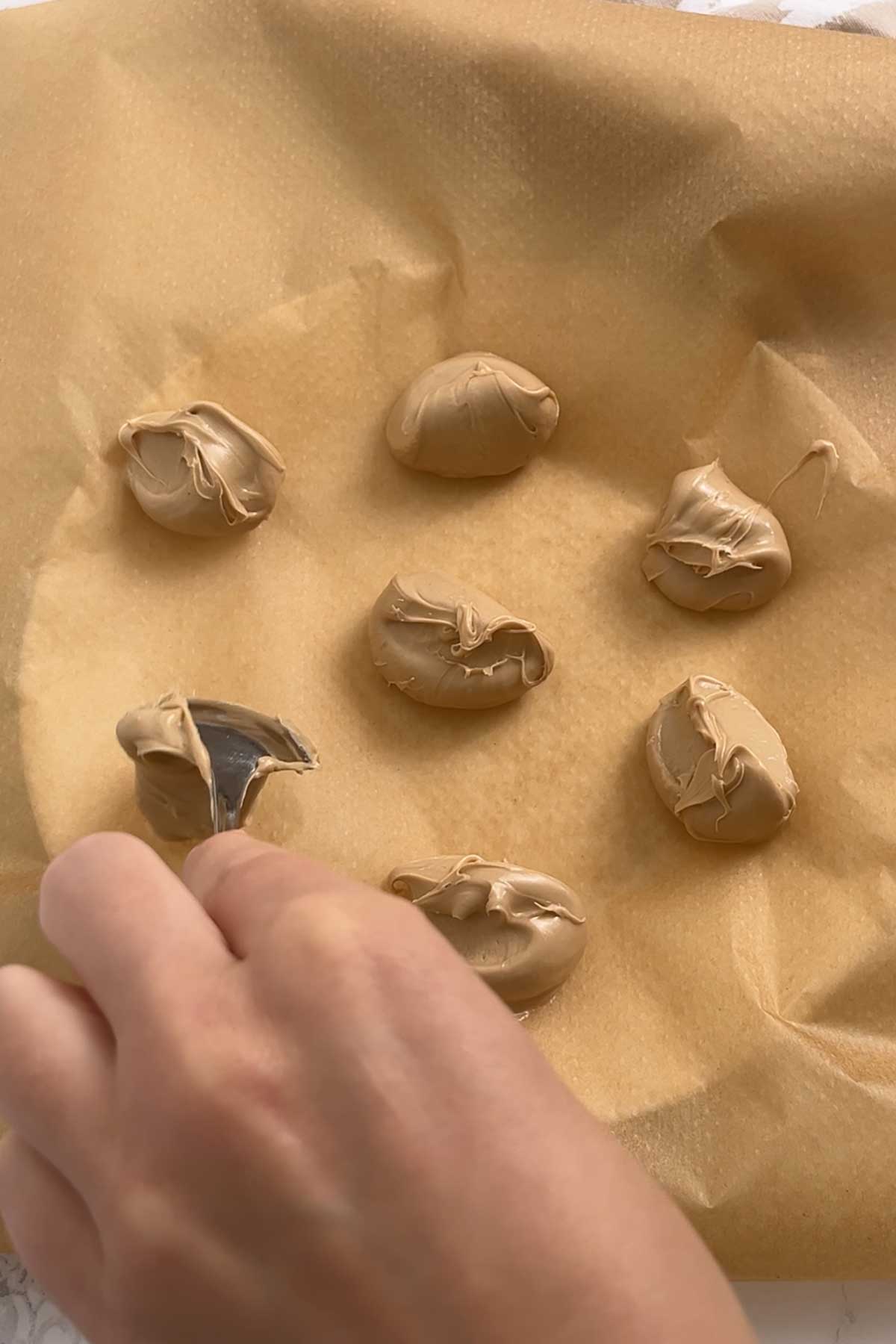 spoonful of hazelnut white chocolate spread on a lined plate