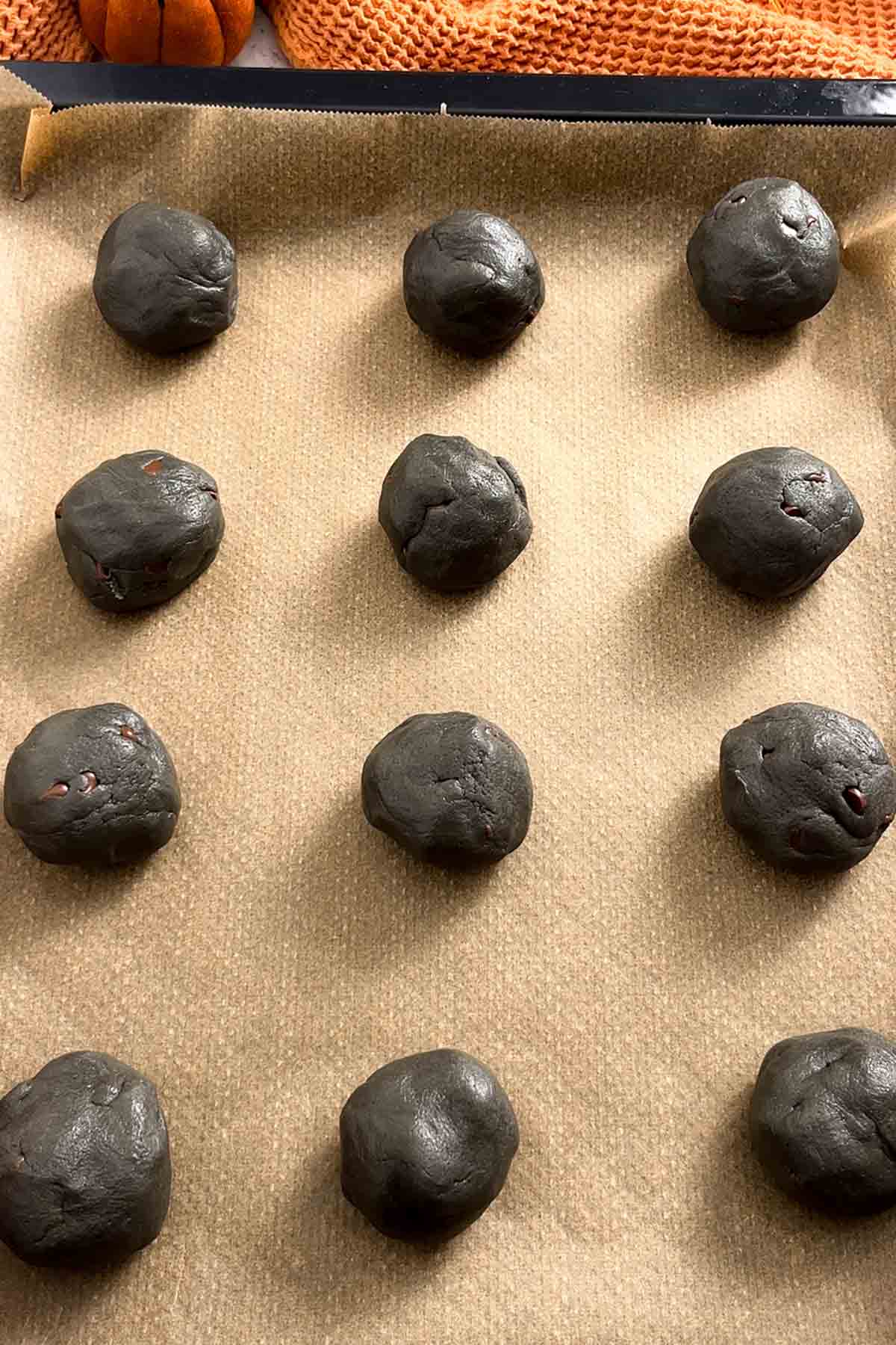 balls of dough on a lined baking tray