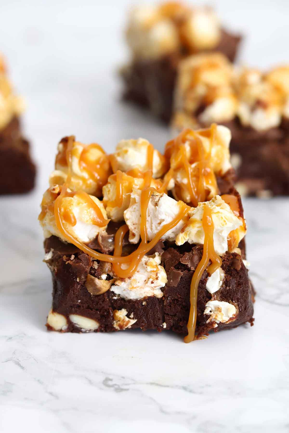 caramel popcorn brownies on a white worktop