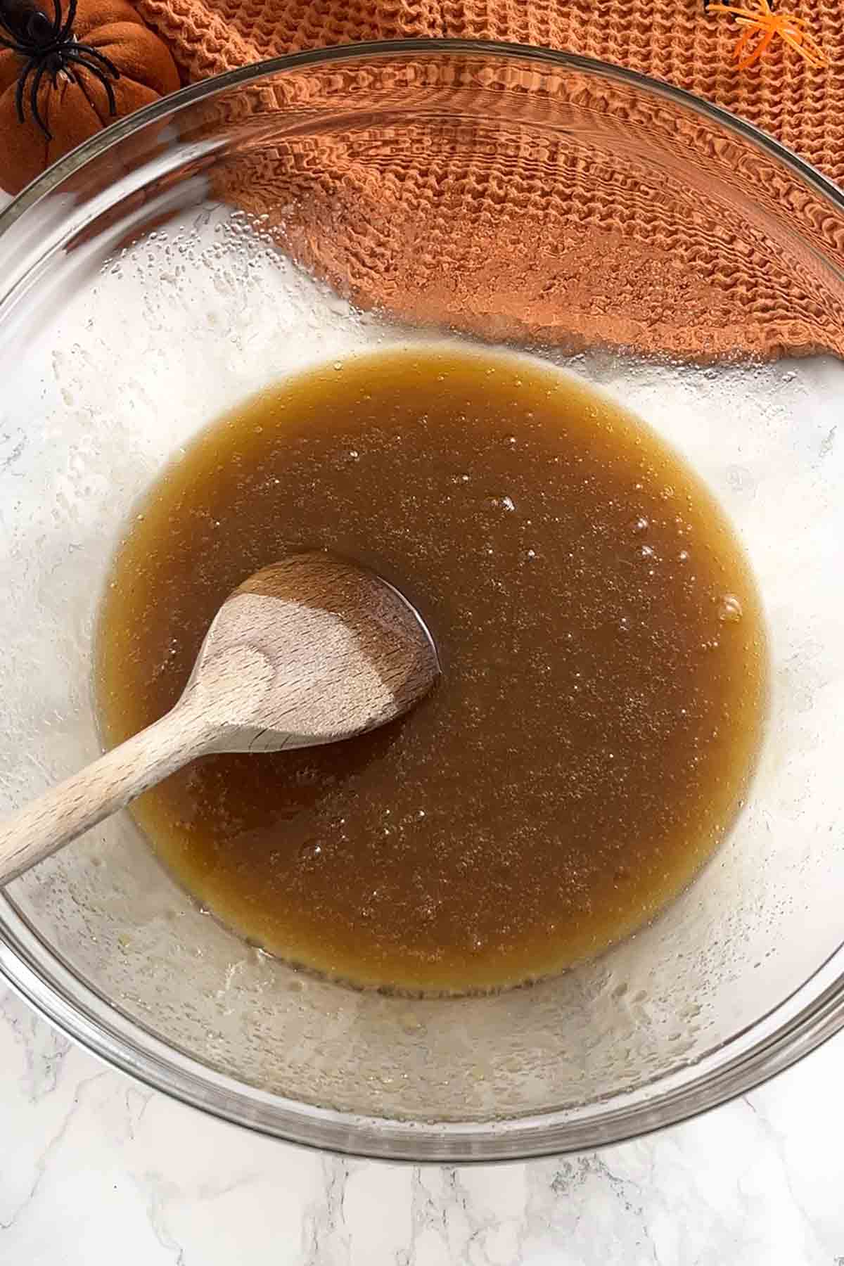 melted butter mixed with sugars in a bowl