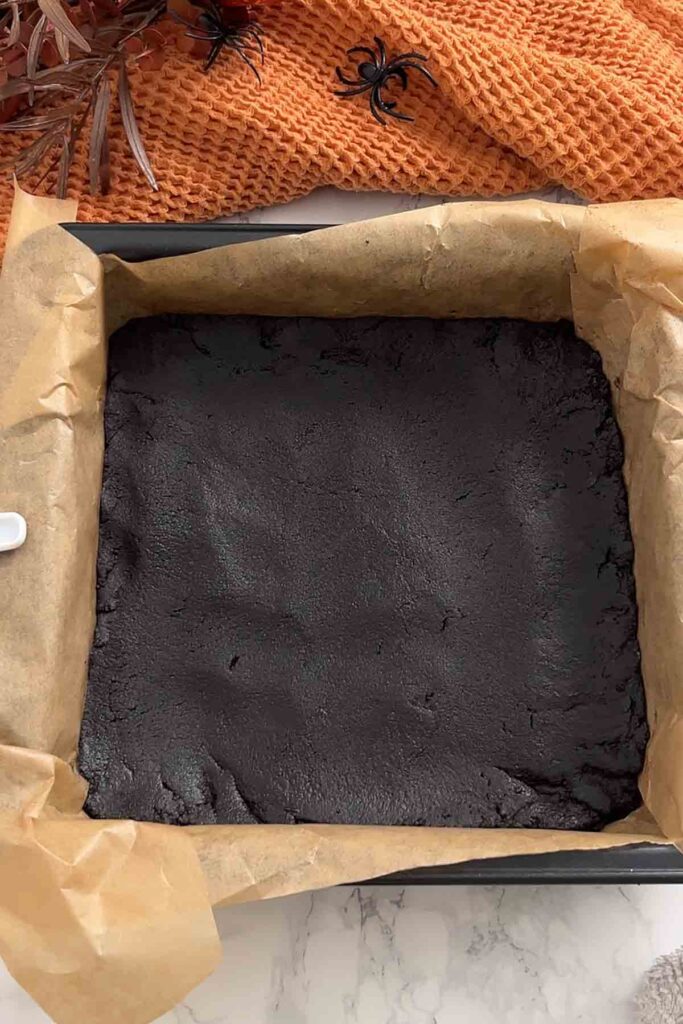 oreo cookie base pressed into a lined tin