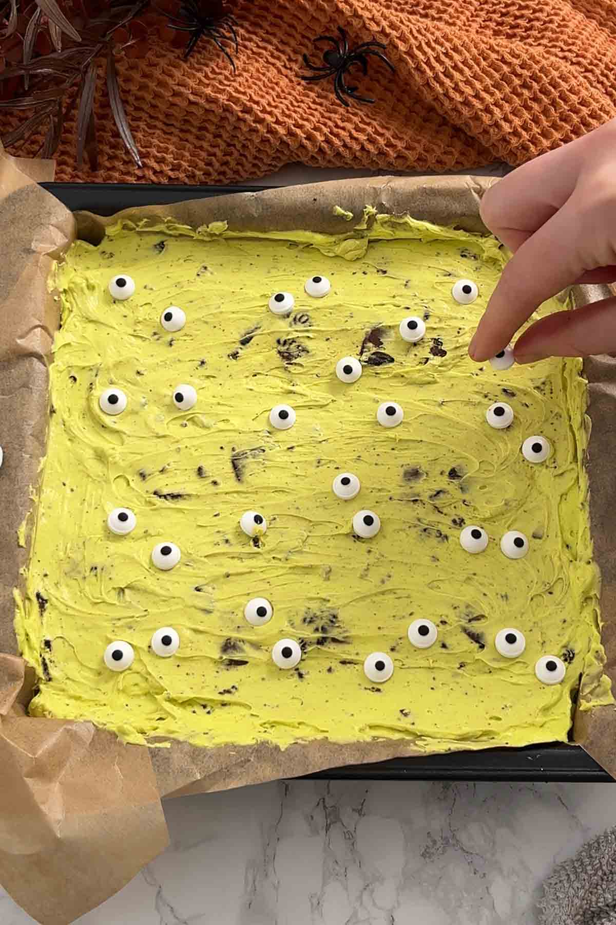 placing halloween eyeball decorations on top