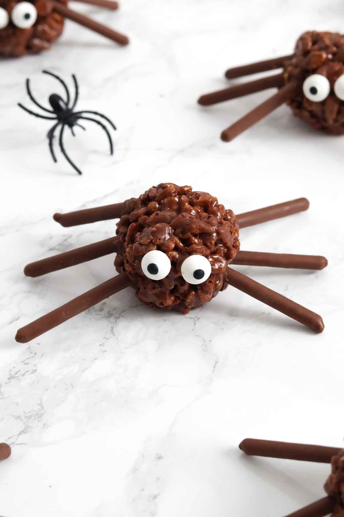 rice krispie halloween spider balls laying on worktop