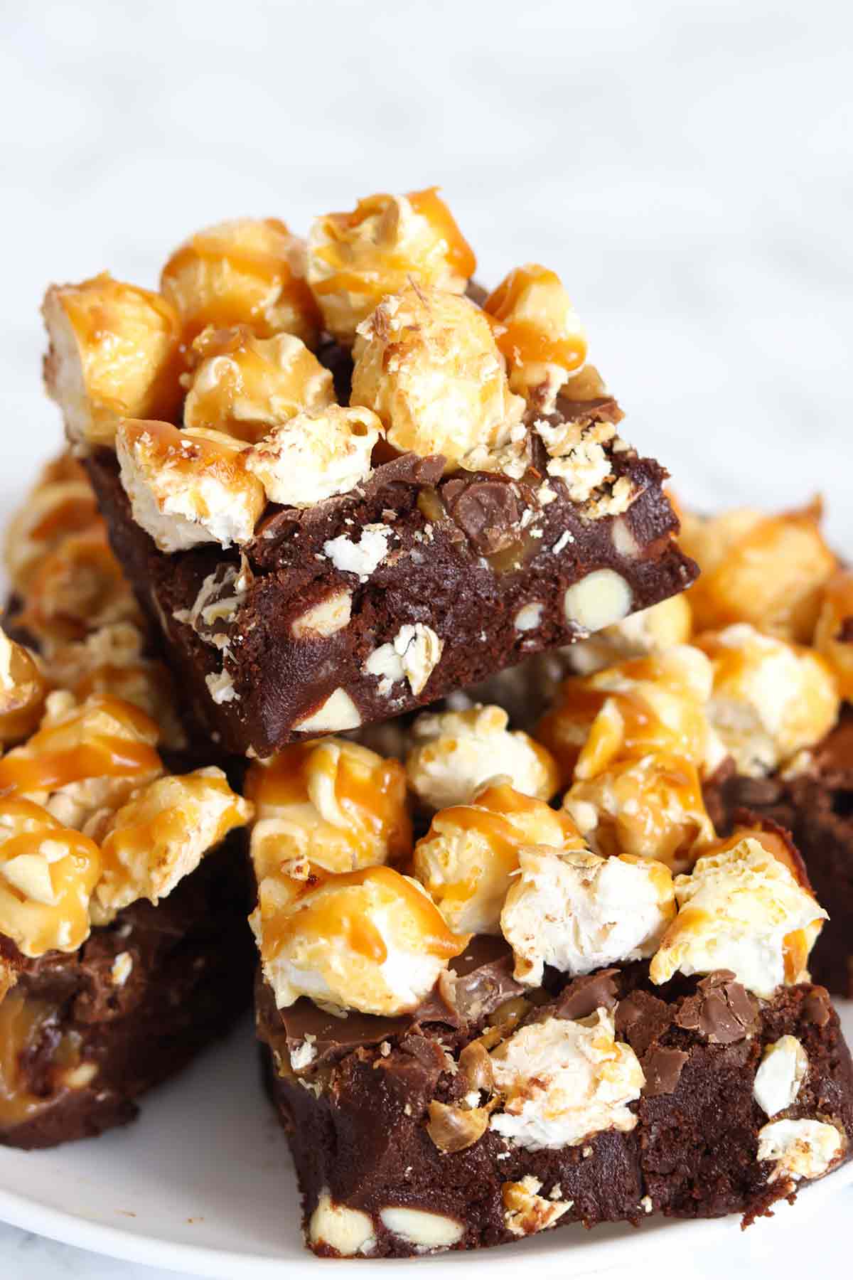 stack of caramel popcorn brownies on a plate