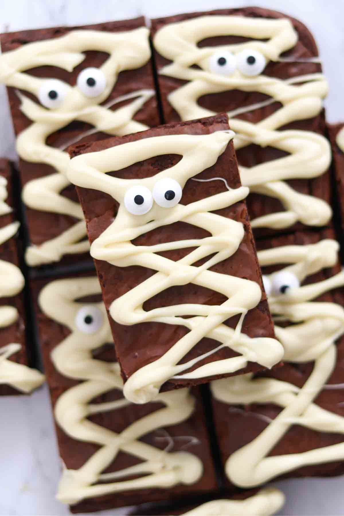 white chocolate mummy brownies stacked on a plate