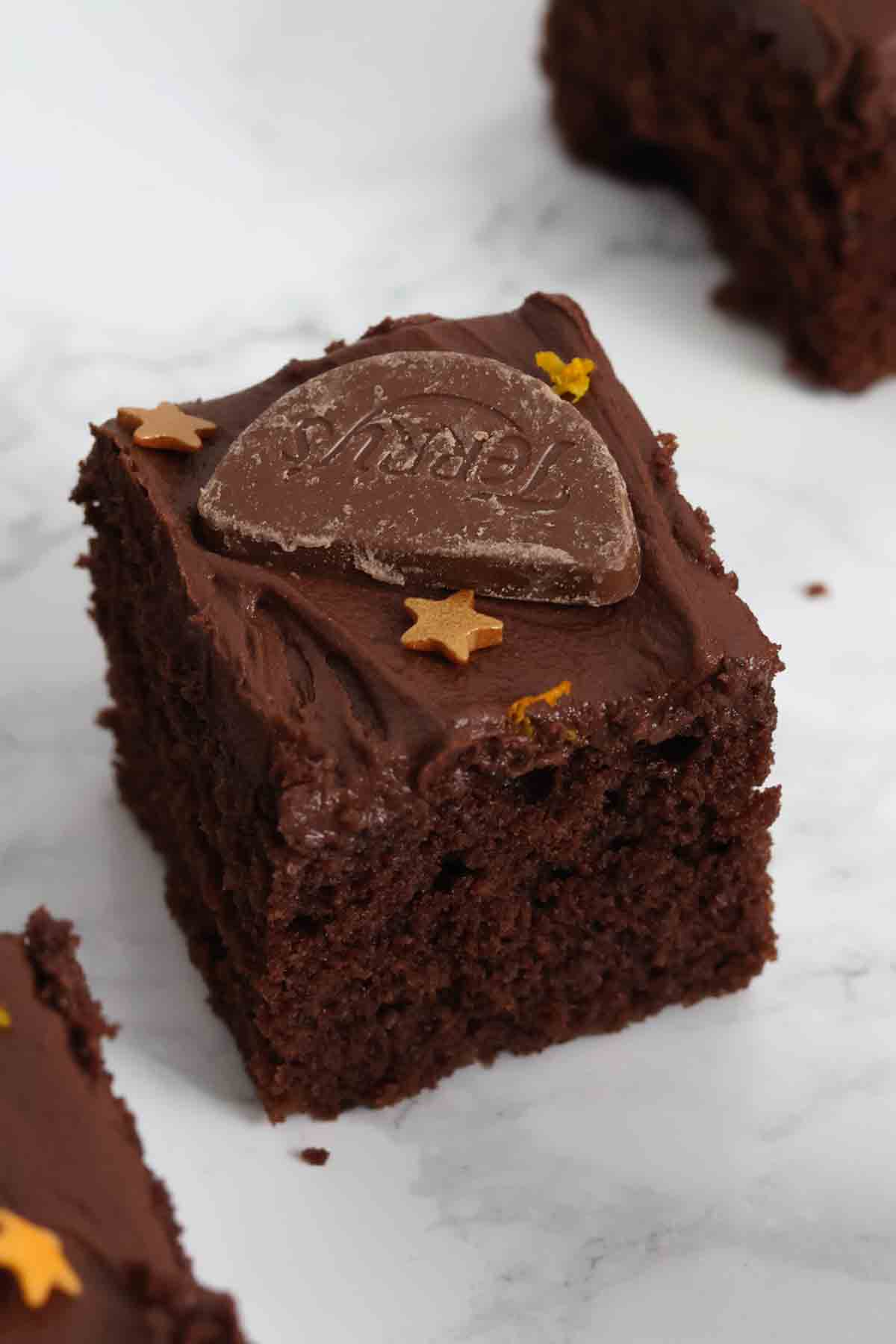 a single slice of chocolate orange tray bake cake with buttercream icing on top