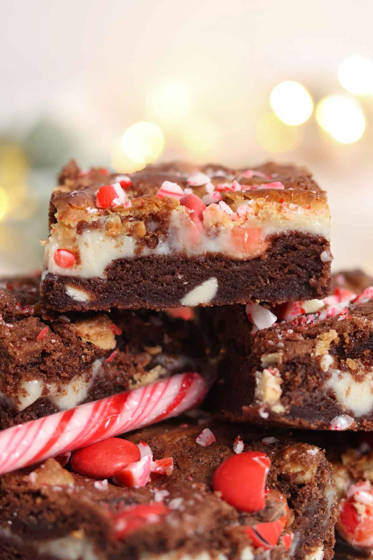 a stack of peppermint bark cookie bars on a plate